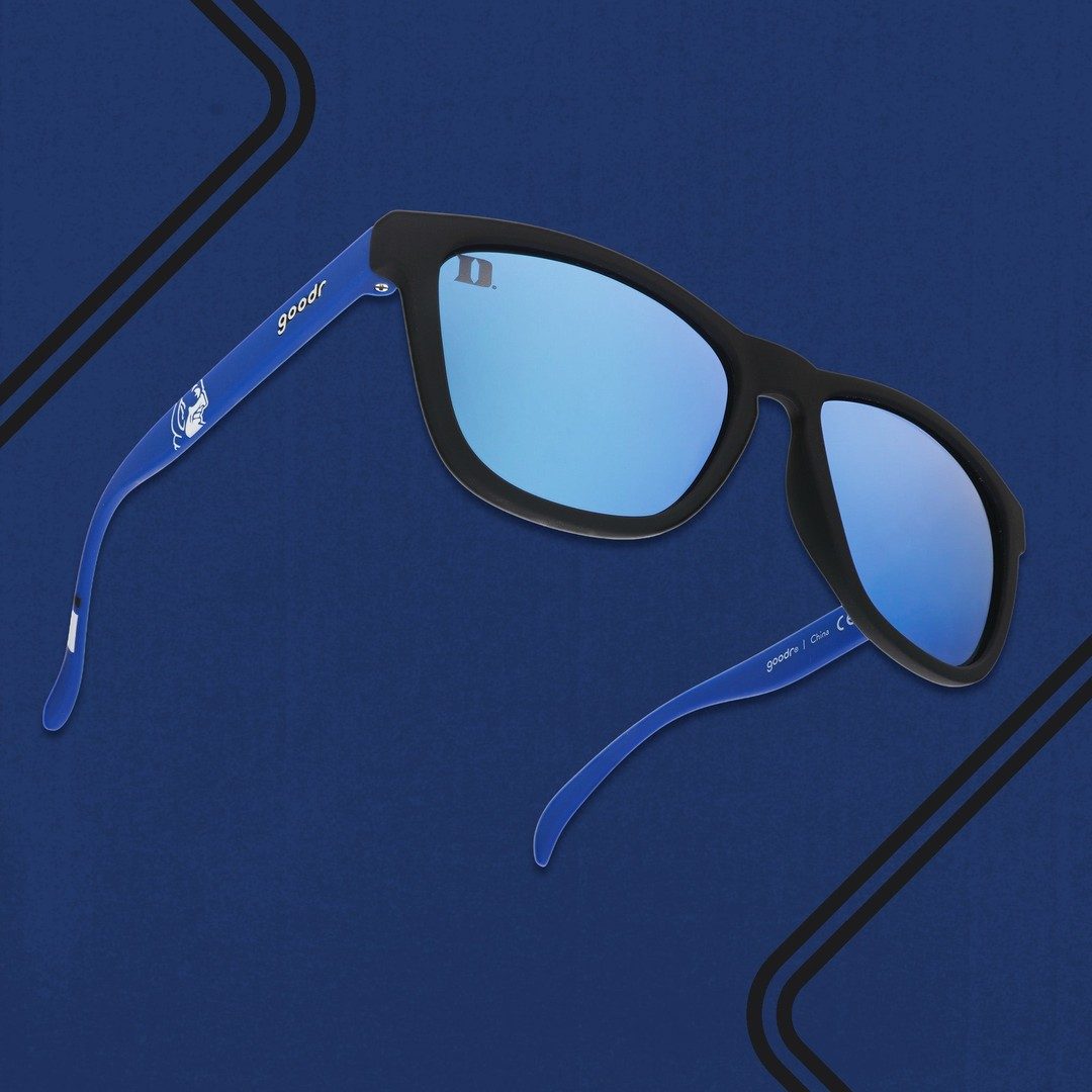 Royal Blue Duke Collegiate OG Polarized Sunglasses with sleek frame, shown worn outdoors in a lifestyle setting.