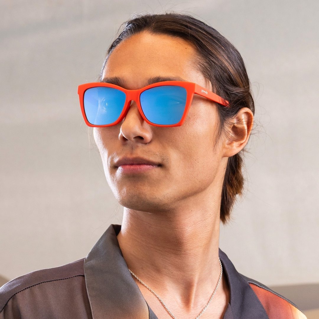 Rare Air Discs polarized Pop G sunglasses featuring a colorful "Kisses Canvas" design, shown worn outdoors in a lifestyle setting.