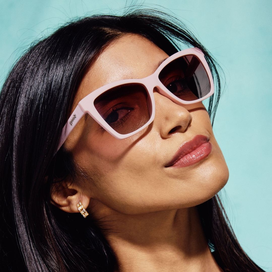 Pair of Rare Air Discs Rosé Retail Therapy polarized Pop G sunglasses, stylish accessories with pink-tinted lenses and sleek black frames
