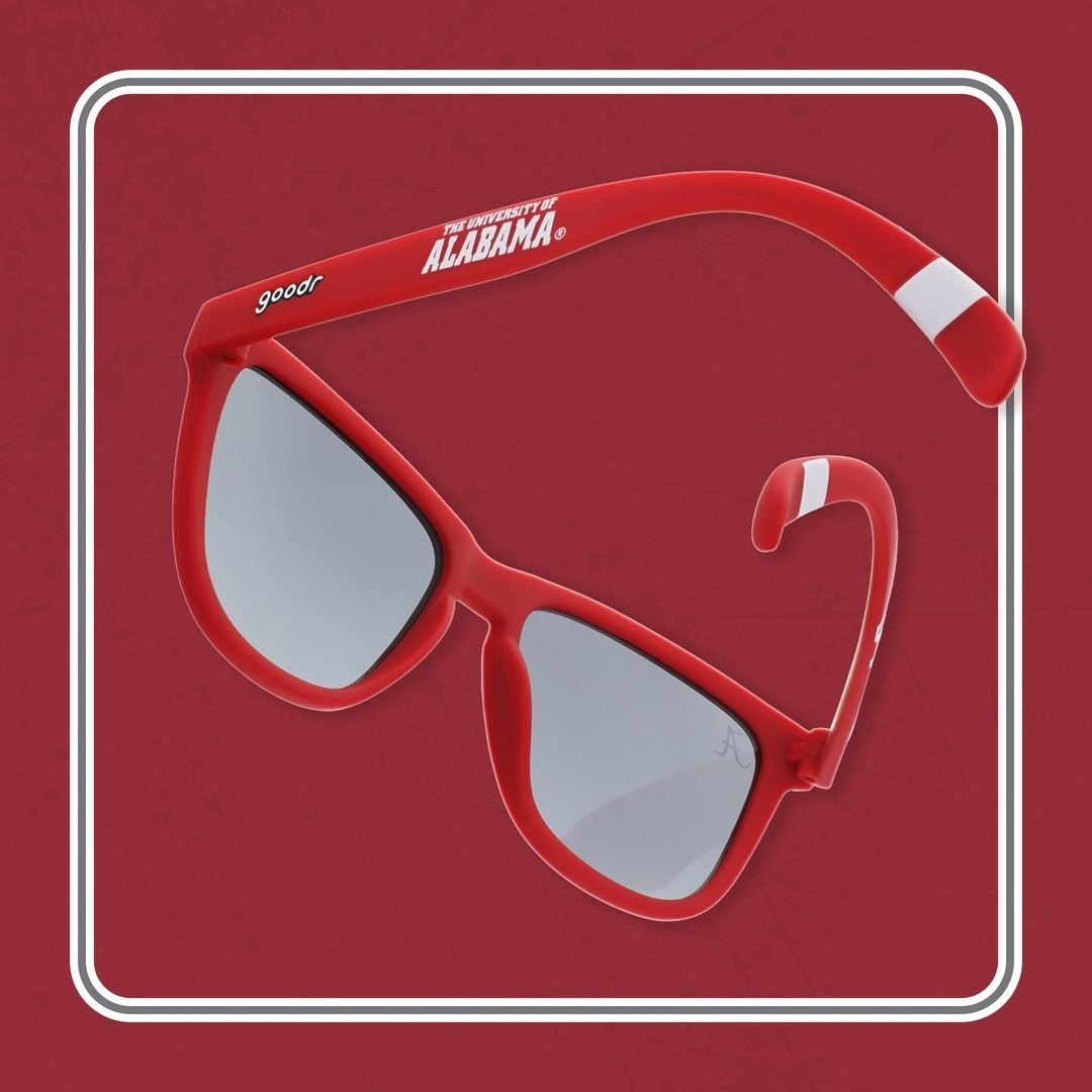 Rare Air Discs Crimson Tide Pride Alabama polarized sunglasses with red frame and dark lenses, displayed in a lifestyle setting.