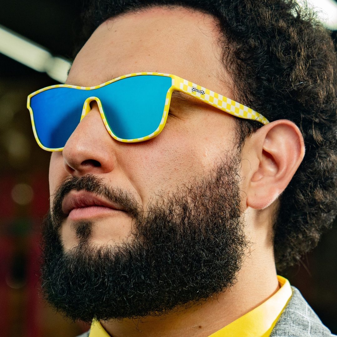 Pair of Warn To Be Wild VRG Premium Polarized Sunglasses by Rare Air Discs shown on a person outdoors, showcasing stylish accessory wear