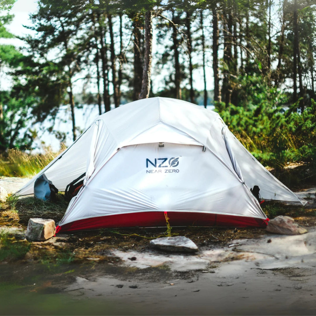 Near Zero Outdoor Gear 3P DynaLite Tent set up outdoors, showcasing lightweight camping tent with rainfly and mesh windows.