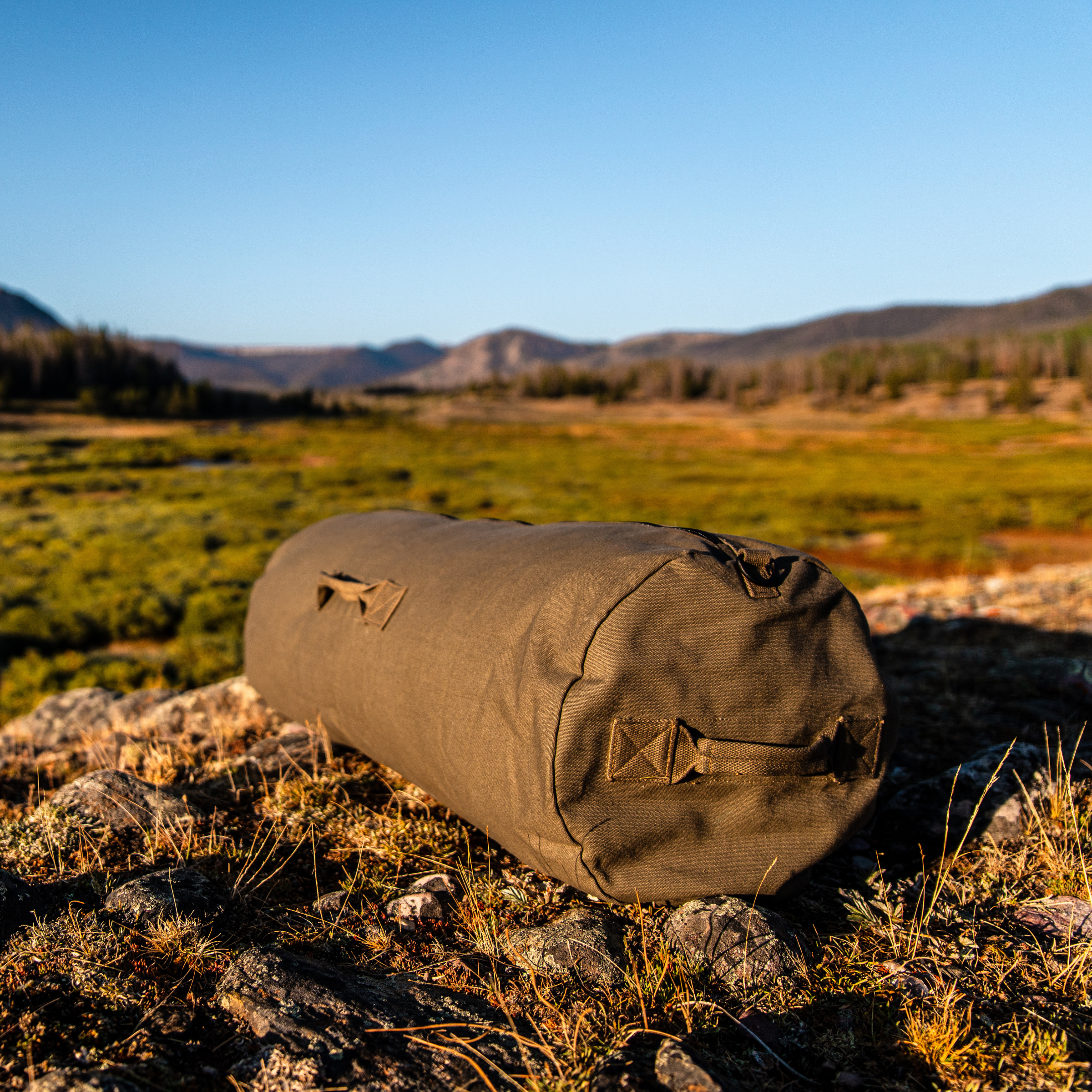 White Duck Outdoors Hoplite Canvas Duffel Bag with sturdy handles and spacious main compartment, ideal for travel or outdoor adventures.