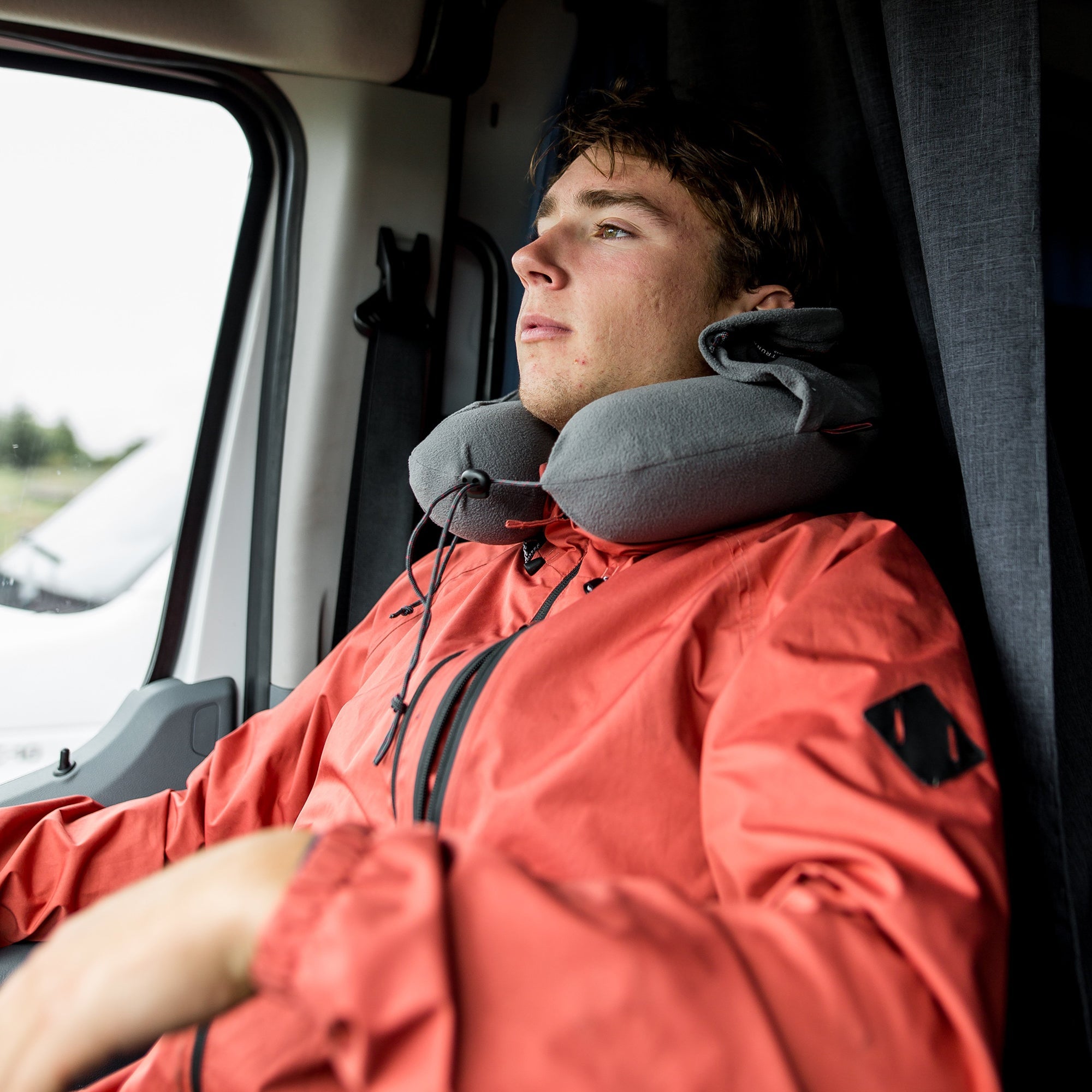 GrandTrunk hooded travel neck pillow in gray, showcasing soft fabric and ergonomic design for comfort during travel.