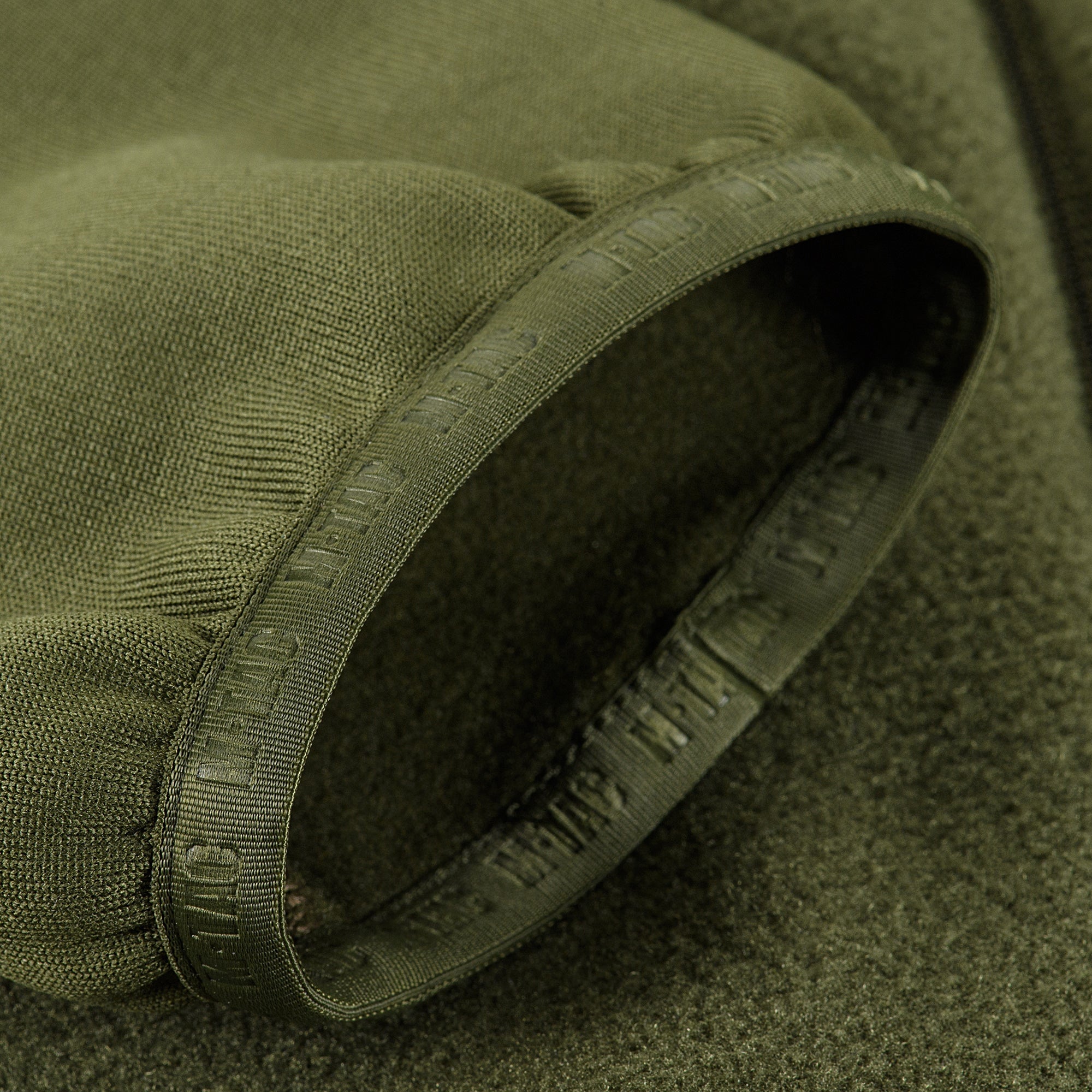 M-TAC Polartec fleece jacket in dark color, showcasing a zip-up front and adjustable cuffs for outdoor sports.