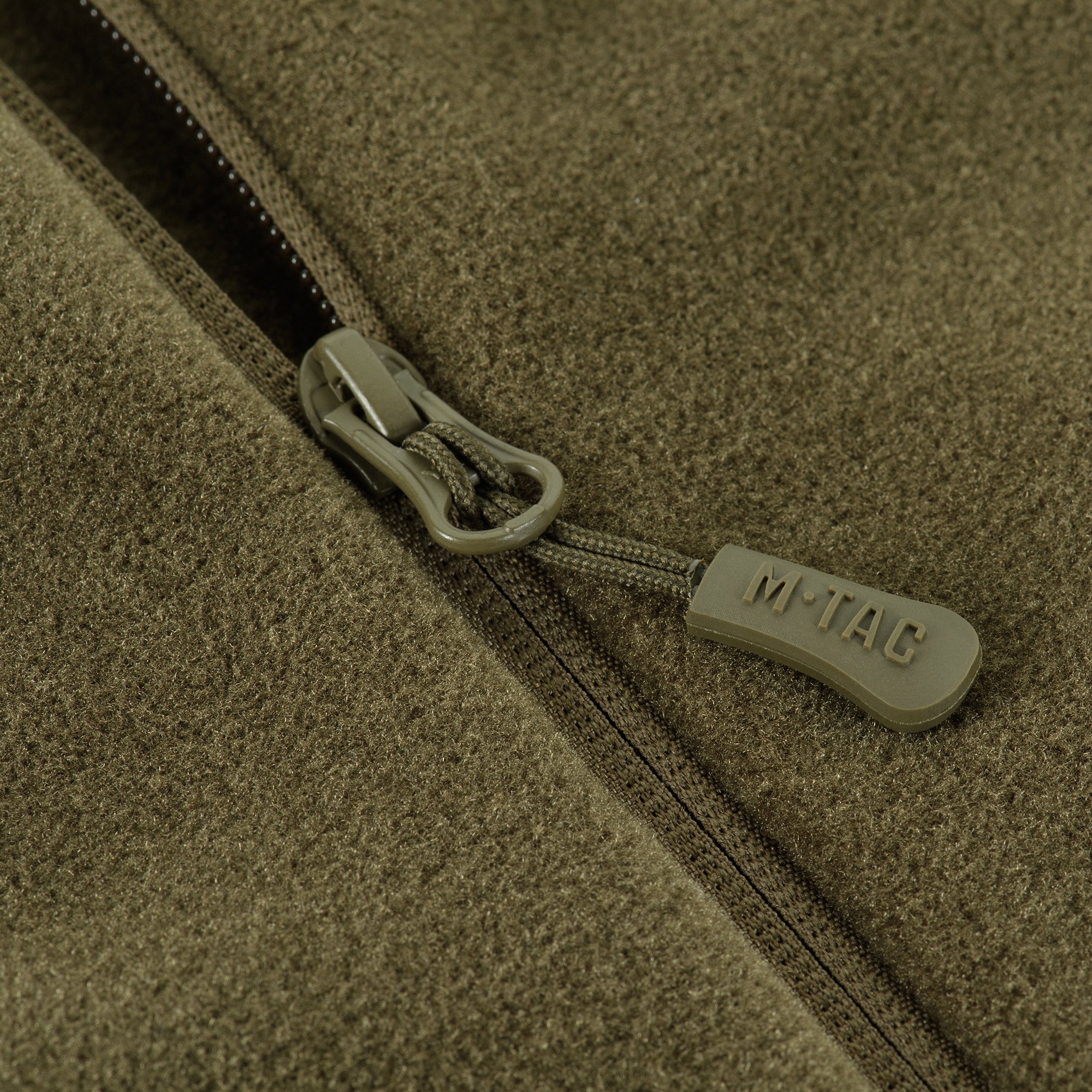 M-TAC Fleece Jacket in Polartec fabric, showcasing a comfortable fit and outdoor-ready design in a rugged environment.