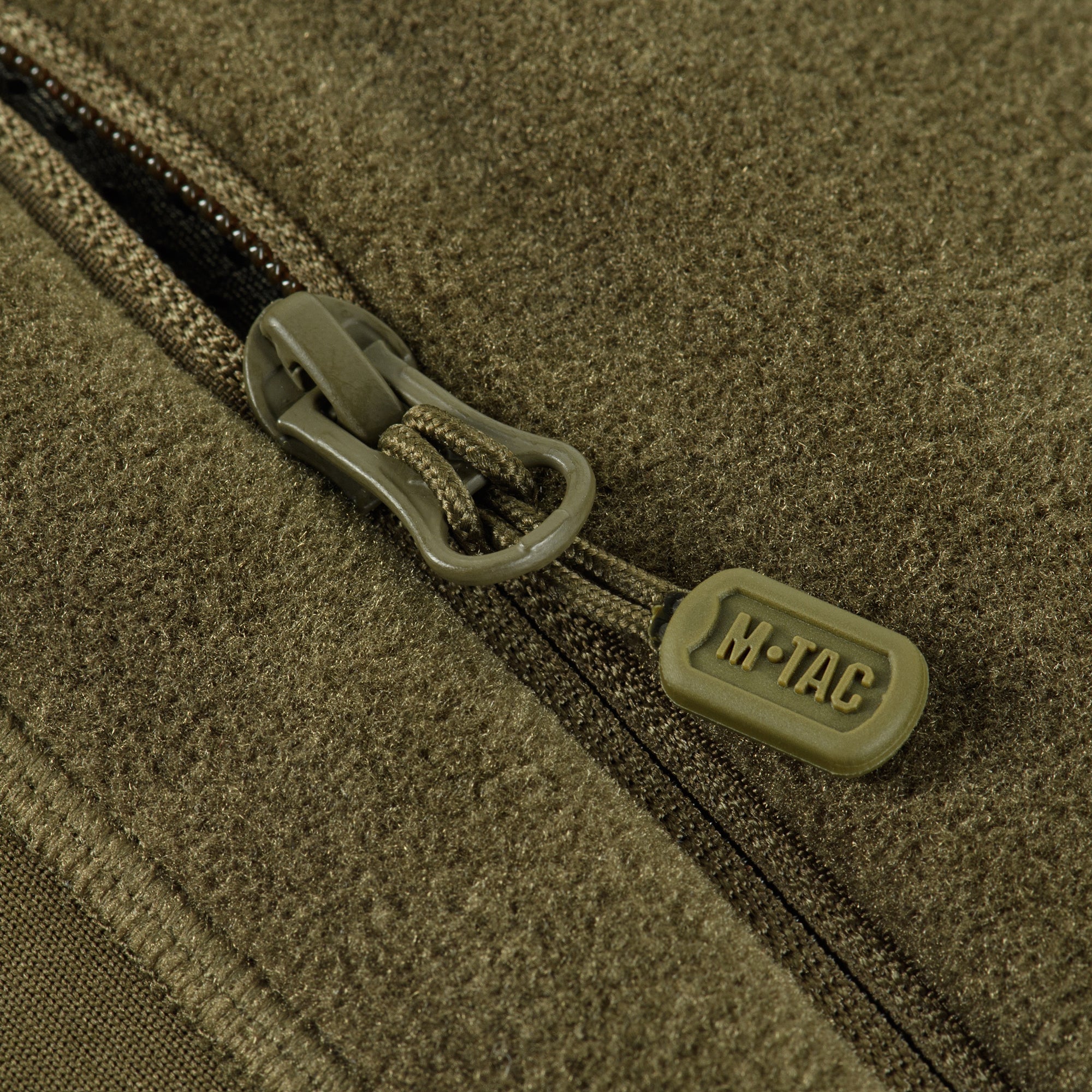 M-TAC fleece jacket made with Polartec fabric, featuring a sporty design and versatile pockets for outdoor activities.