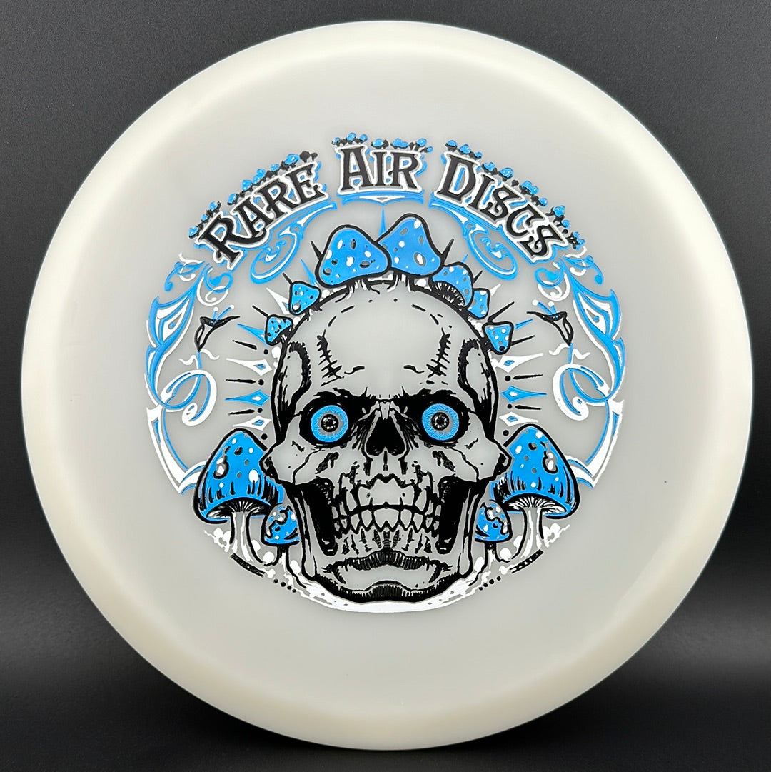 Forged Radiant Supra disc golf stamp by Manny Trujillo featuring Crushin' Amanitas design on a Rare Air Discs disc.