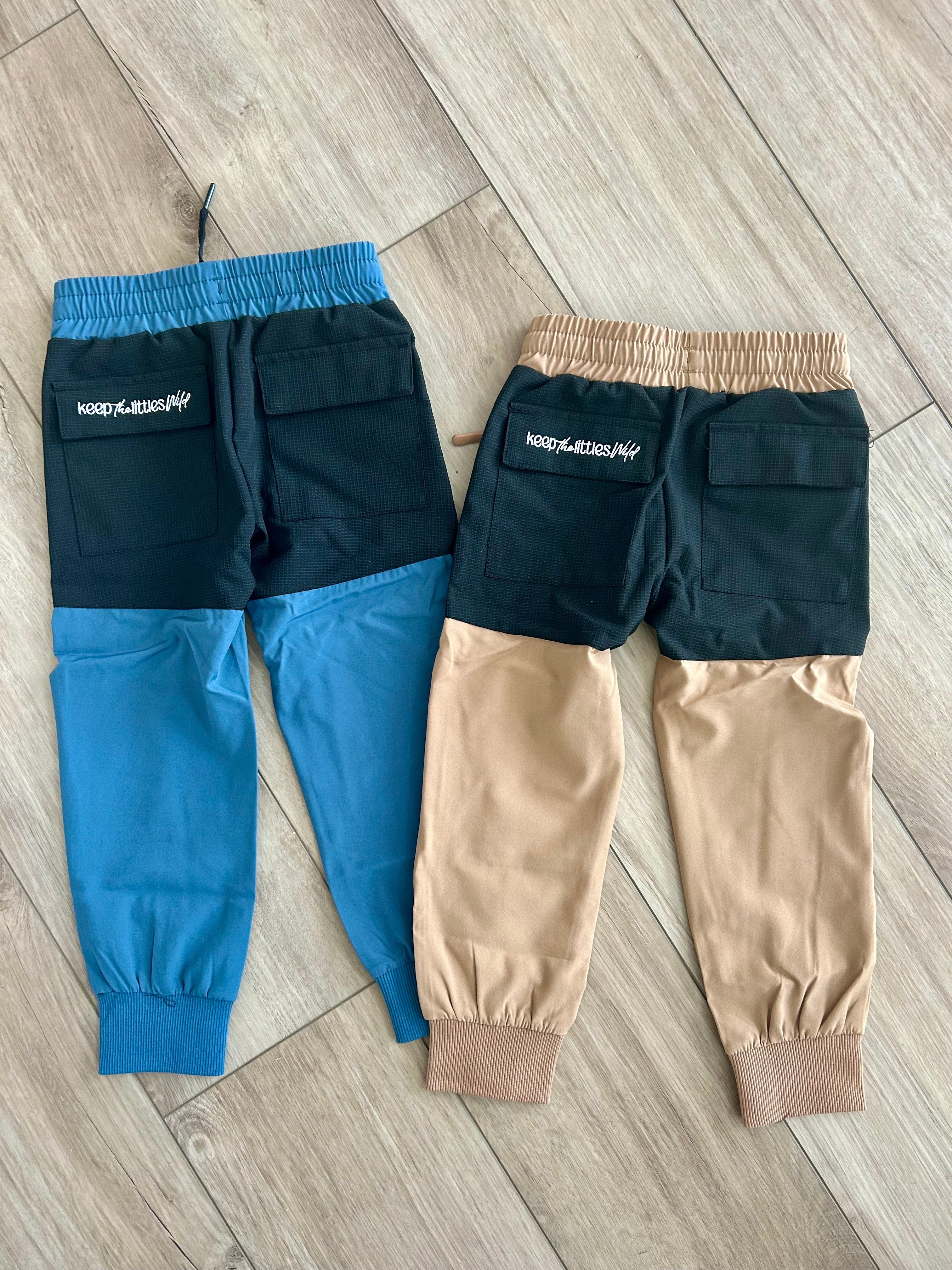 Water-resistant tan hiking pants by Keep the Littles Wild, showcasing durable fabric and comfortable fit for outdoor adventures.