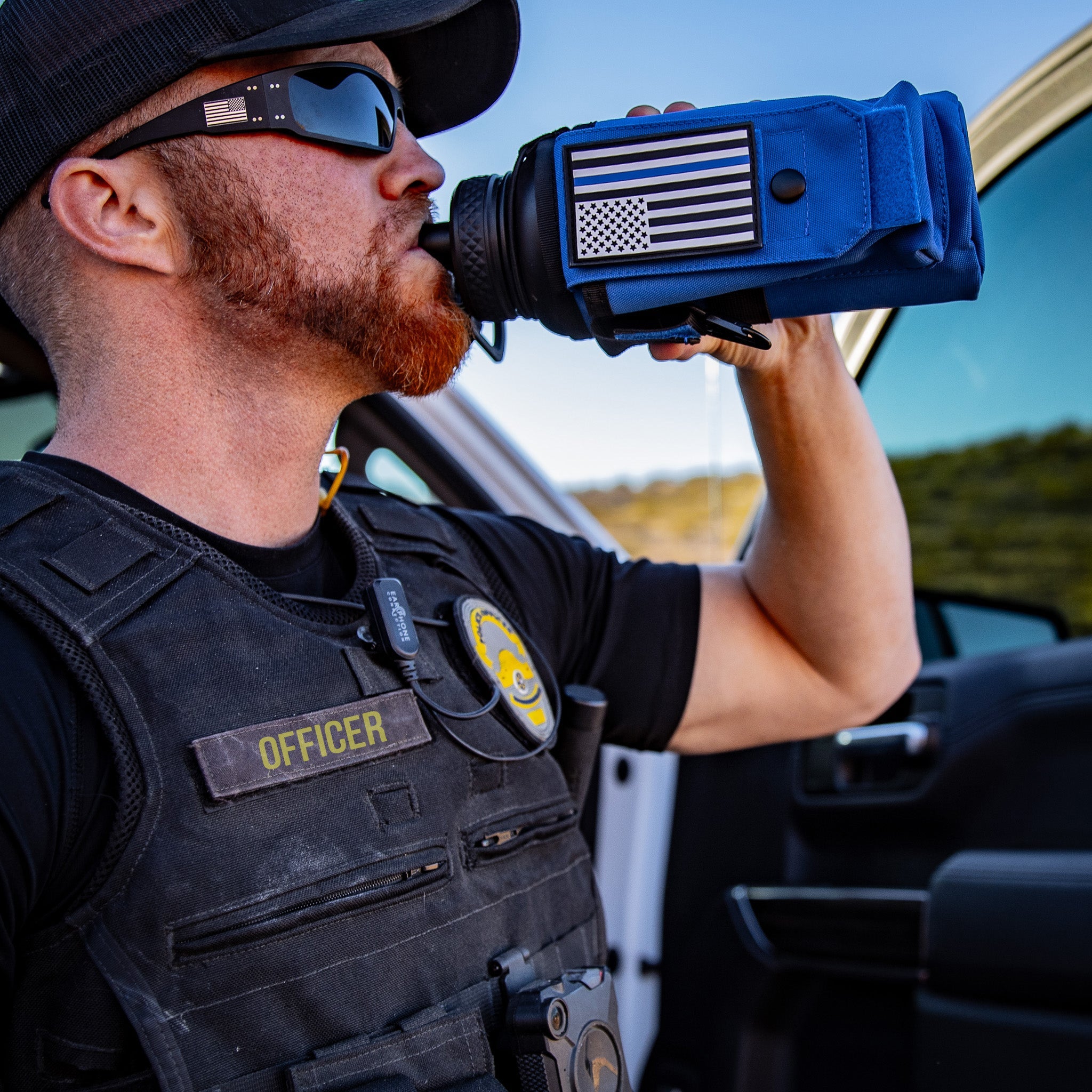 Iron Infidel 32oz compact water bottle with a black lid and rugged design, suitable for outdoor and workout use.