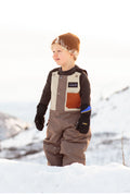 Waterproof snow bib for youth and toddlers by Keep the Littles Wild, showing the bib’s adjustable straps and durable waterproof fabric.