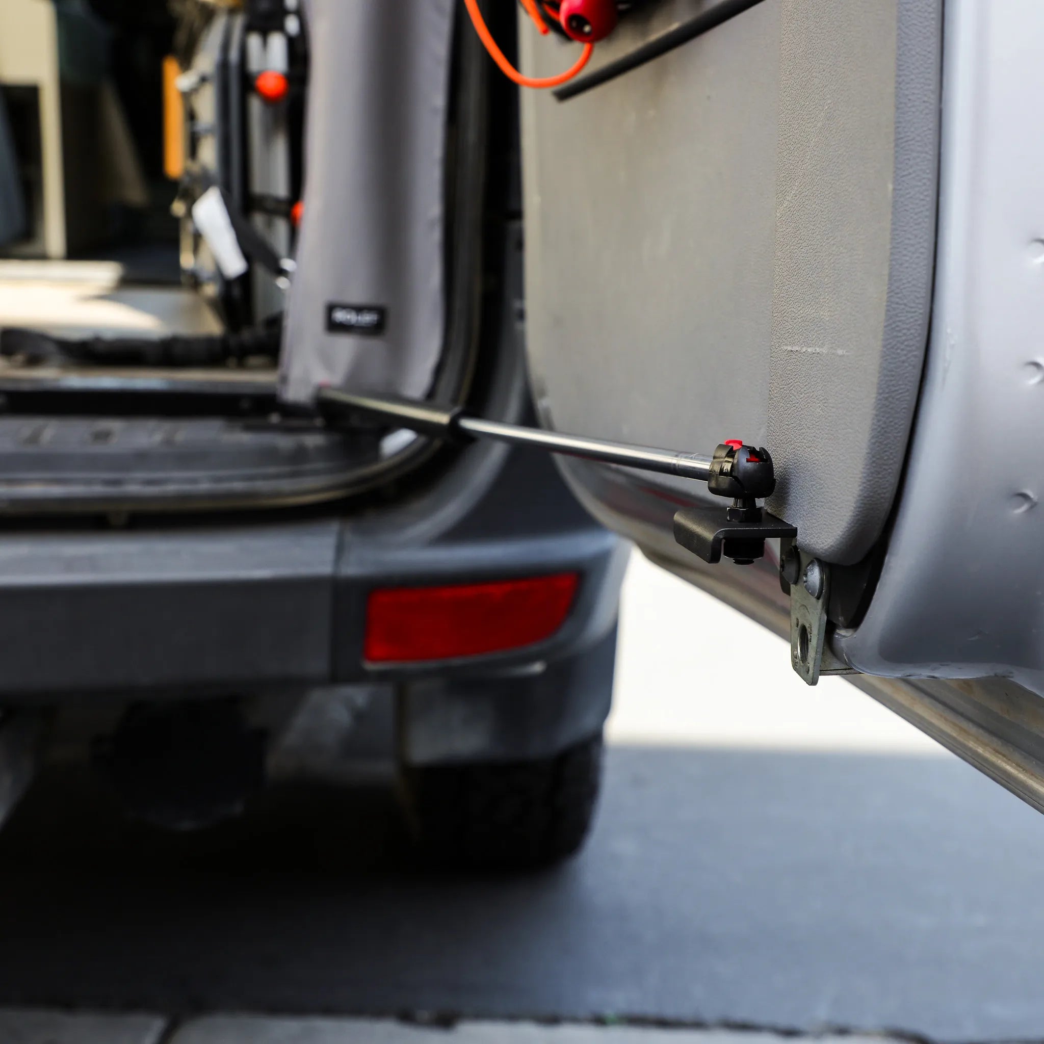 Canyon Adventure Vans STOP-STAY™ door safety system for Mercedes Sprinter van, showing the patented CAV-branded hardware in use.