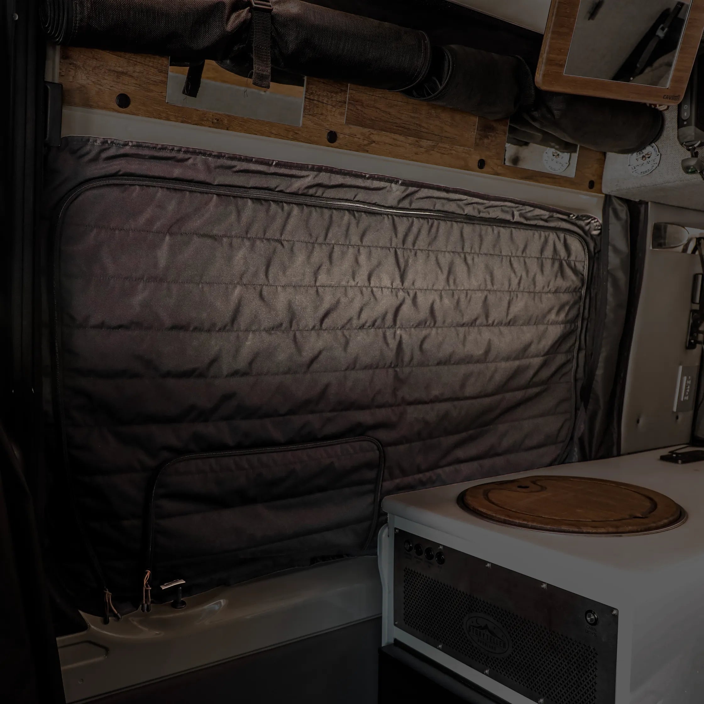 Canyon Adventure Vans CLIMA-SHADE insulated sliding door window cover for Storyteller Overland Mode vehicle inside the van.