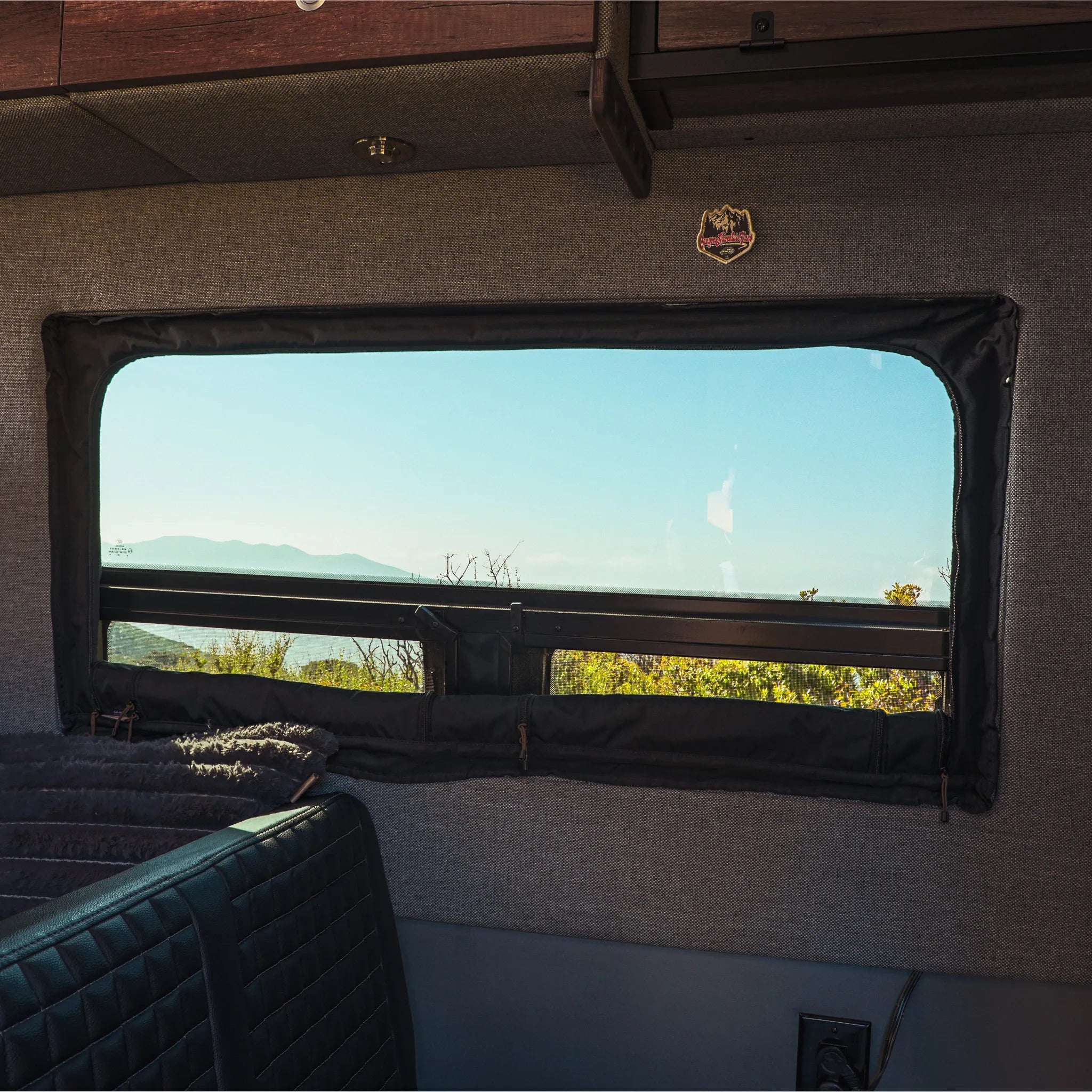 Canyon Adventure Vans CLIMA-SHADE™ insulated groove lounge window cover for CAV branded van windows, providing shade and insulation.