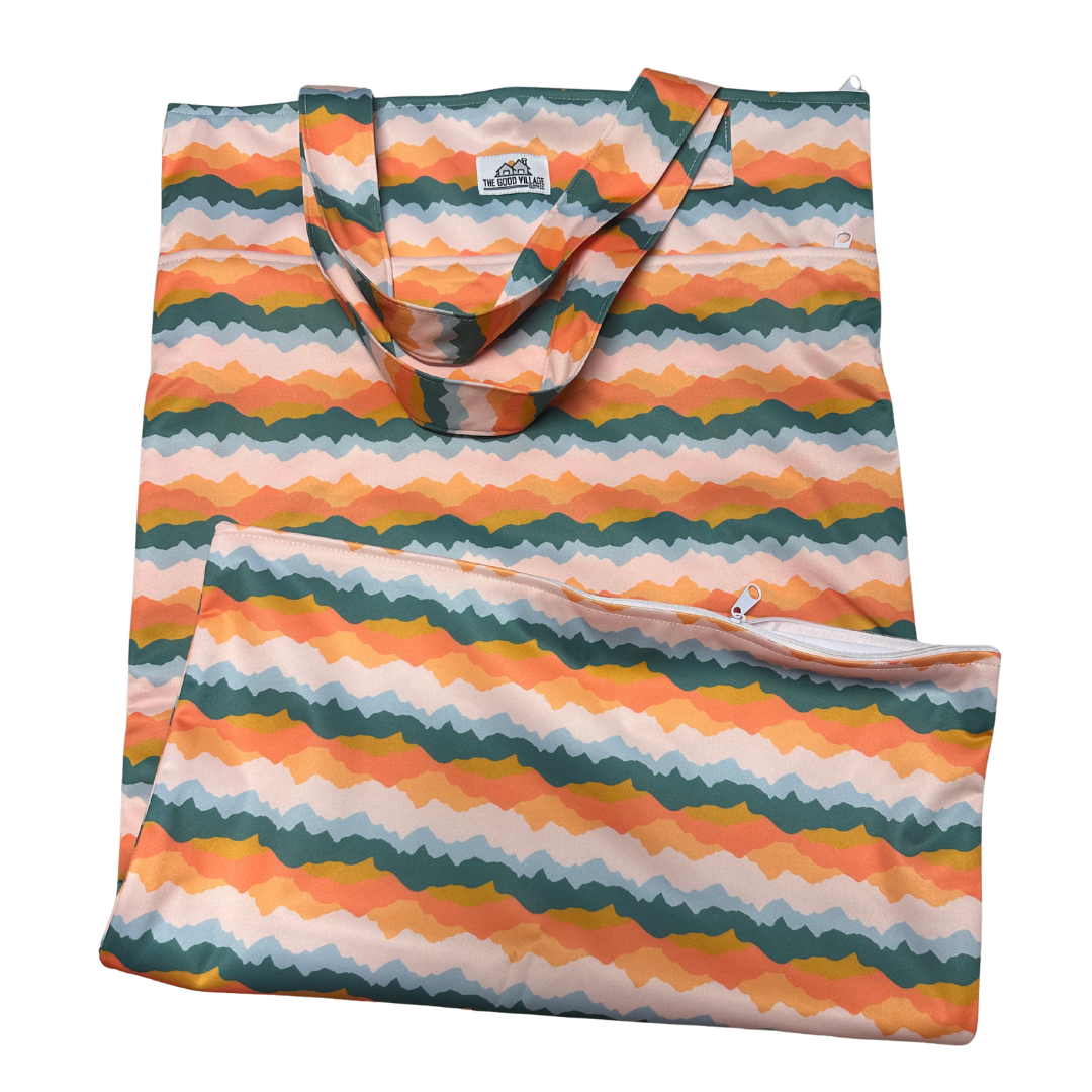 Large Sunset Peaks hanging wetbag from The Good Village Cloth Co. with adjustable strap and waterproof interior for cloth diapers.