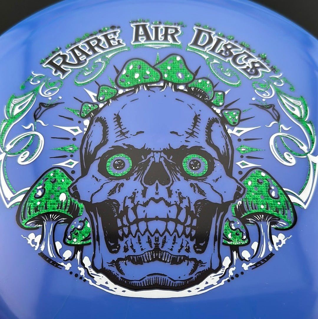 Ethereal Construct Crushin' Amanitas disc golf stamp by Manny Trujillo on a Rare Air Discs disc with intricate cosmic design.