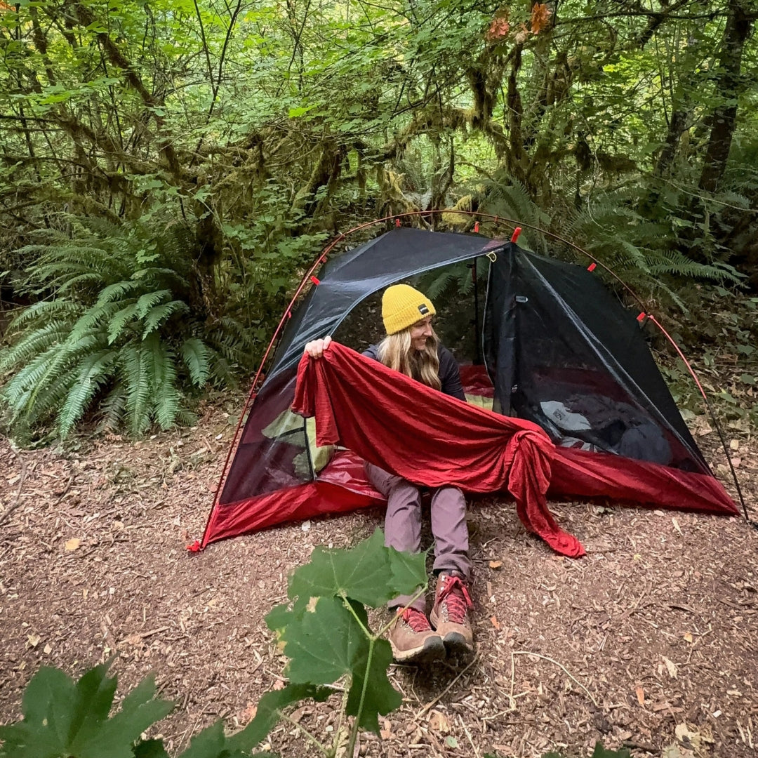 Near Zero Outdoor Gear sleeping bag liner displayed, showcasing its lightweight fabric and compact design for camping use.