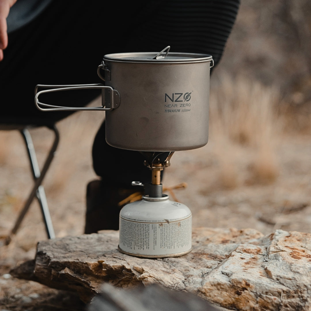 Near Zero Outdoor Gear mini stove accessory, compact camping stove with metallic finish and control knob, suitable for outdoor cooking.