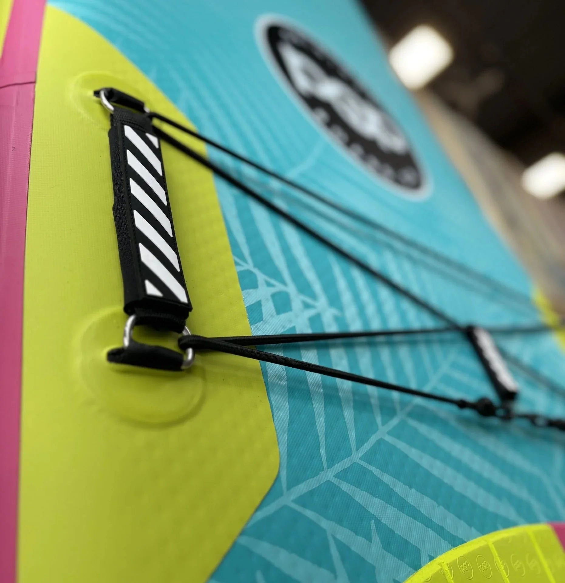 Backcountry Sportsman 11'0 Yacht Hopper paddleboard in mint, teak, and blue with a sleek design and standing area.