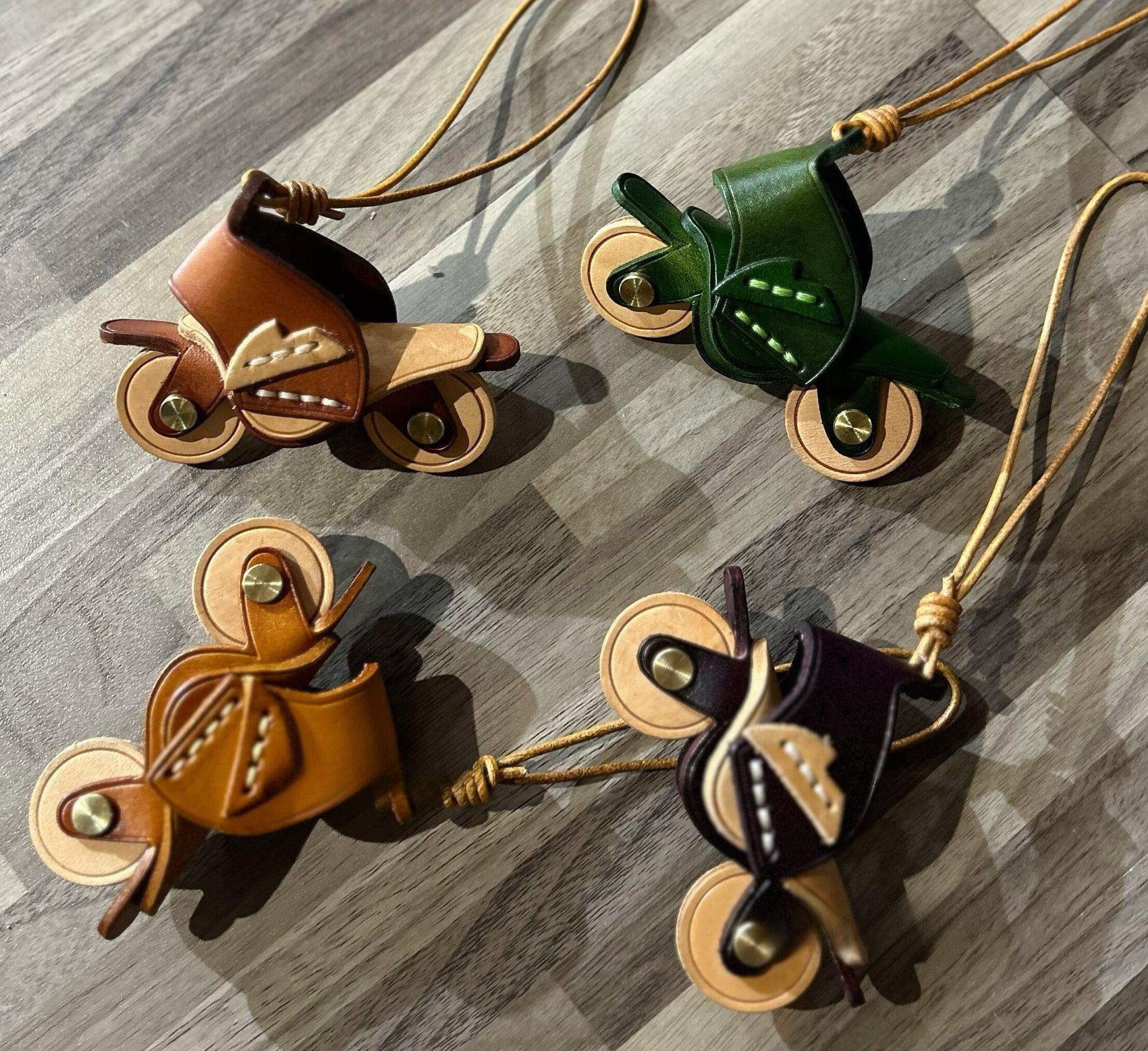 Handcrafted genuine leather motorcycle pendant decor with detailed motorcycle design from Bean's Moto Booth.