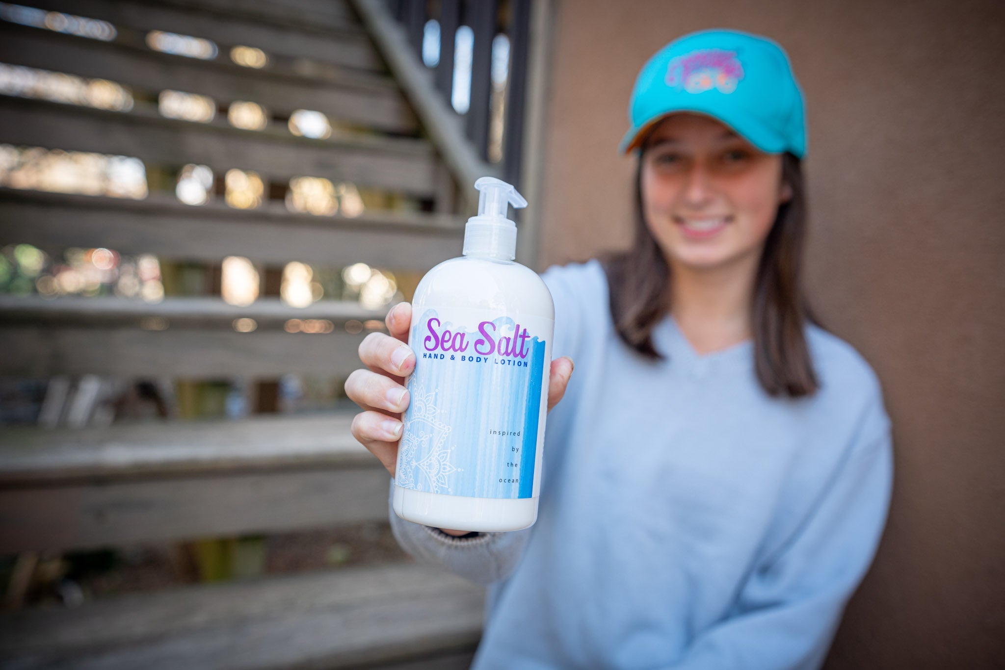 Essential Journeys sea salt hand and body lotion in a 16 oz or 2 oz jar, showing the creamy texture and salt-infused formula.