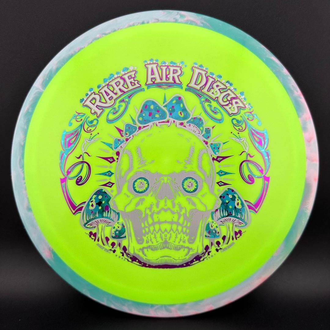 Fission Defy Crushin' Amanitas VIP 2.0 disc golf disc by Rare Air Discs, with vibrant colorful design on a white background.