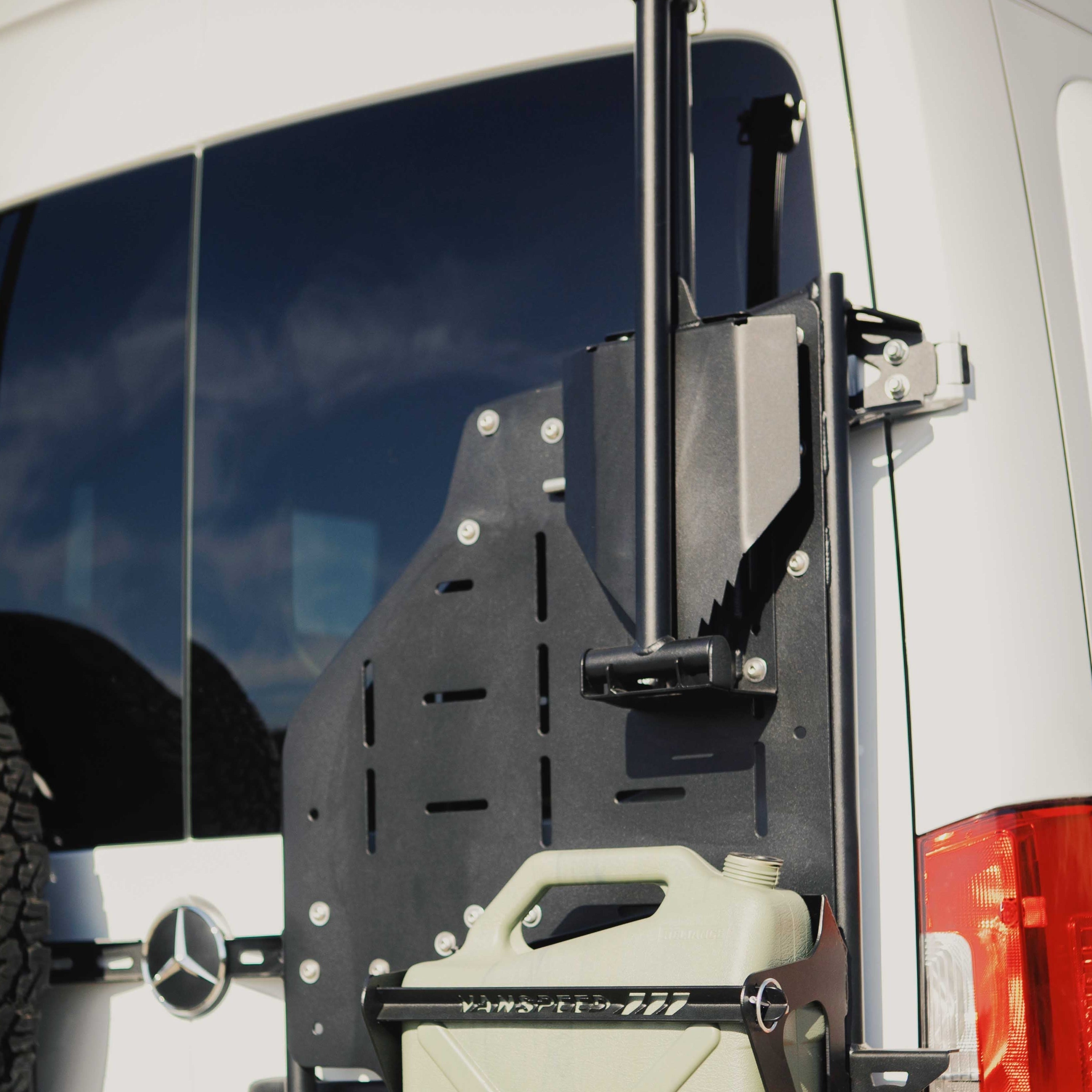 Sprinter Mule Pack Shovel Mount Set by The Van Mart, mounted on a van, showcasing durable exterior parts for outdoor use.
