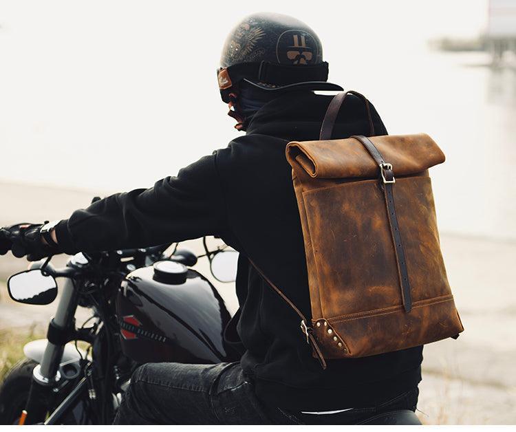 Filed Leather™ vintage roll-top motorcycle backpack in crazy horse cowhide leather with leather straps and rugged design.