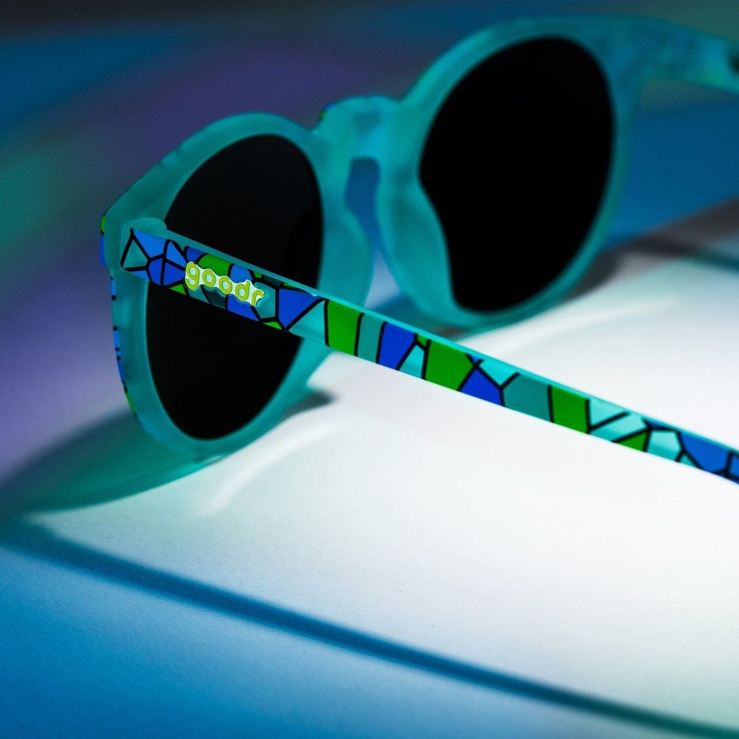Close-up of "Moody Mosaic Musings" Limited Circle G polarized sunglasses in packaging, showcasing colorful mosaic design and brand details.