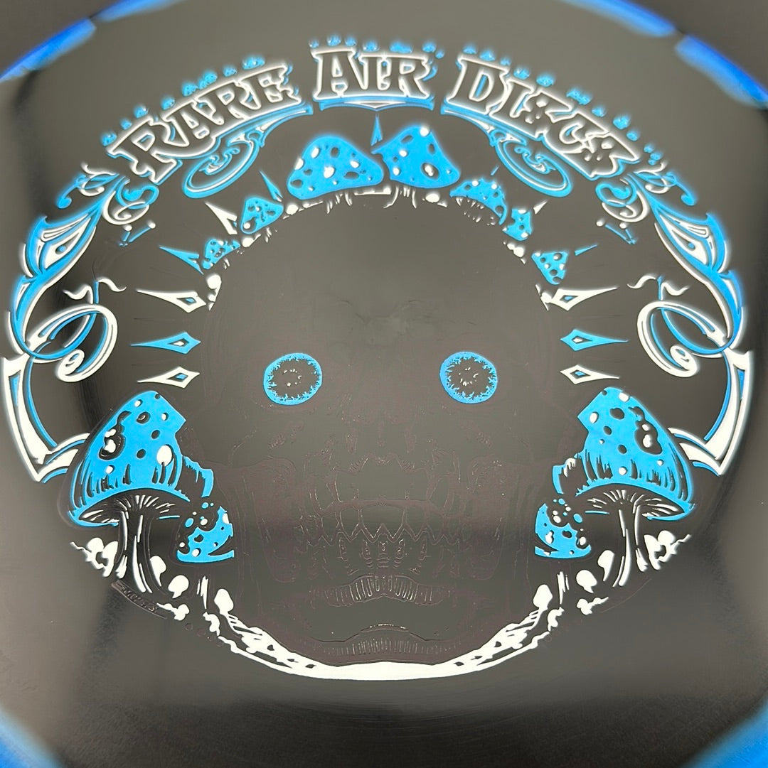 Disc golf disc from Rare Air Discs, Halo S-Blend Tomb Crushin' Amanitas stamp by Manny Trujillo, featuring vibrant colors and detailed design.