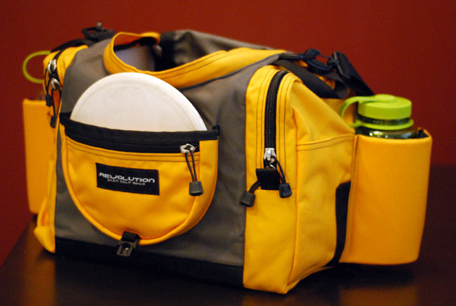 Gotta Go Gotta Throw Revolution Carolina Team V3 disc golf bag in golden dream with multiple compartments and adjustable straps.