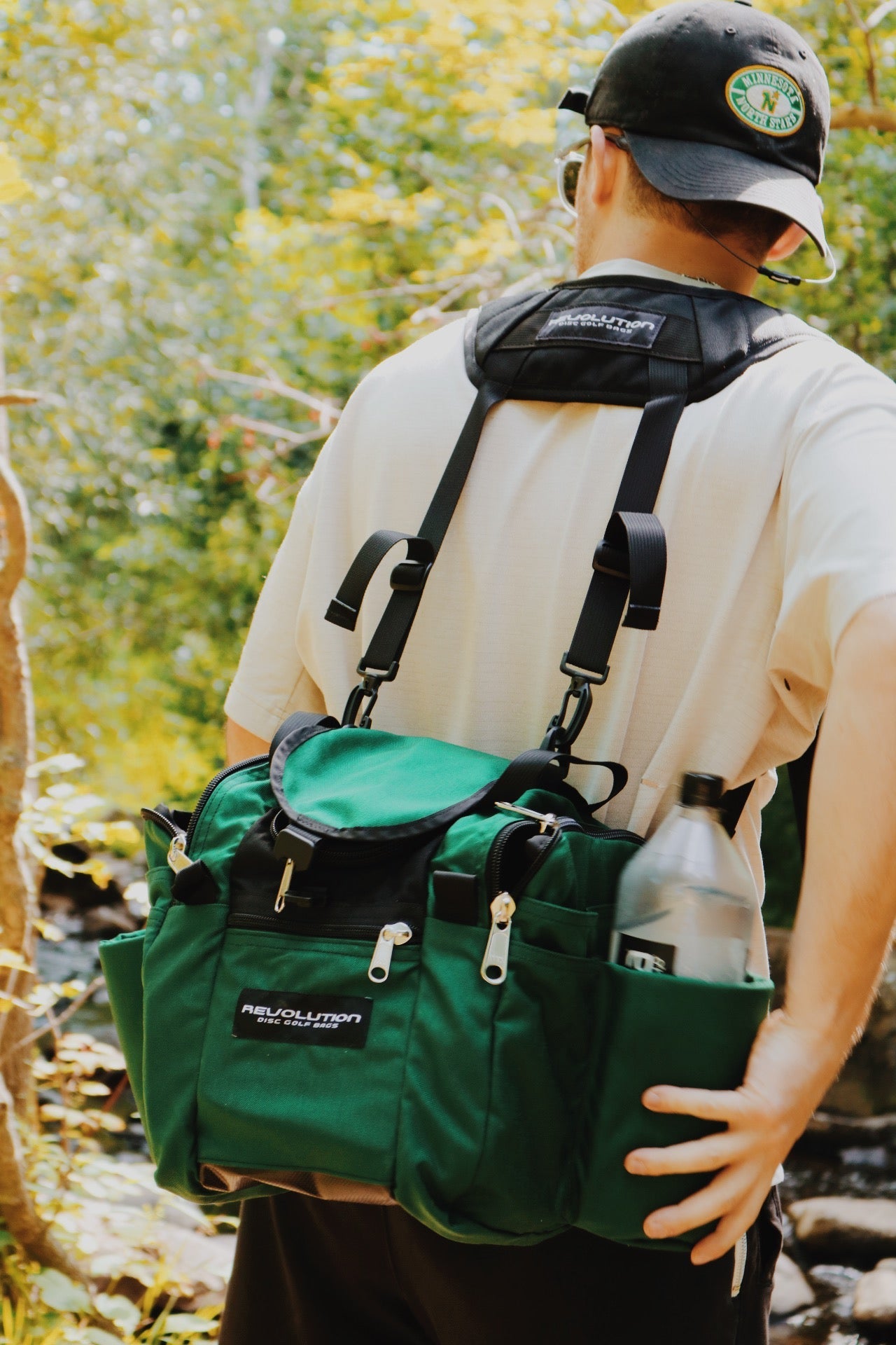 Gotta Go Gotta Throw Revolution Mini Deluxe V3 Disc Golf Bag in forest green with multiple storage compartments and adjustable straps