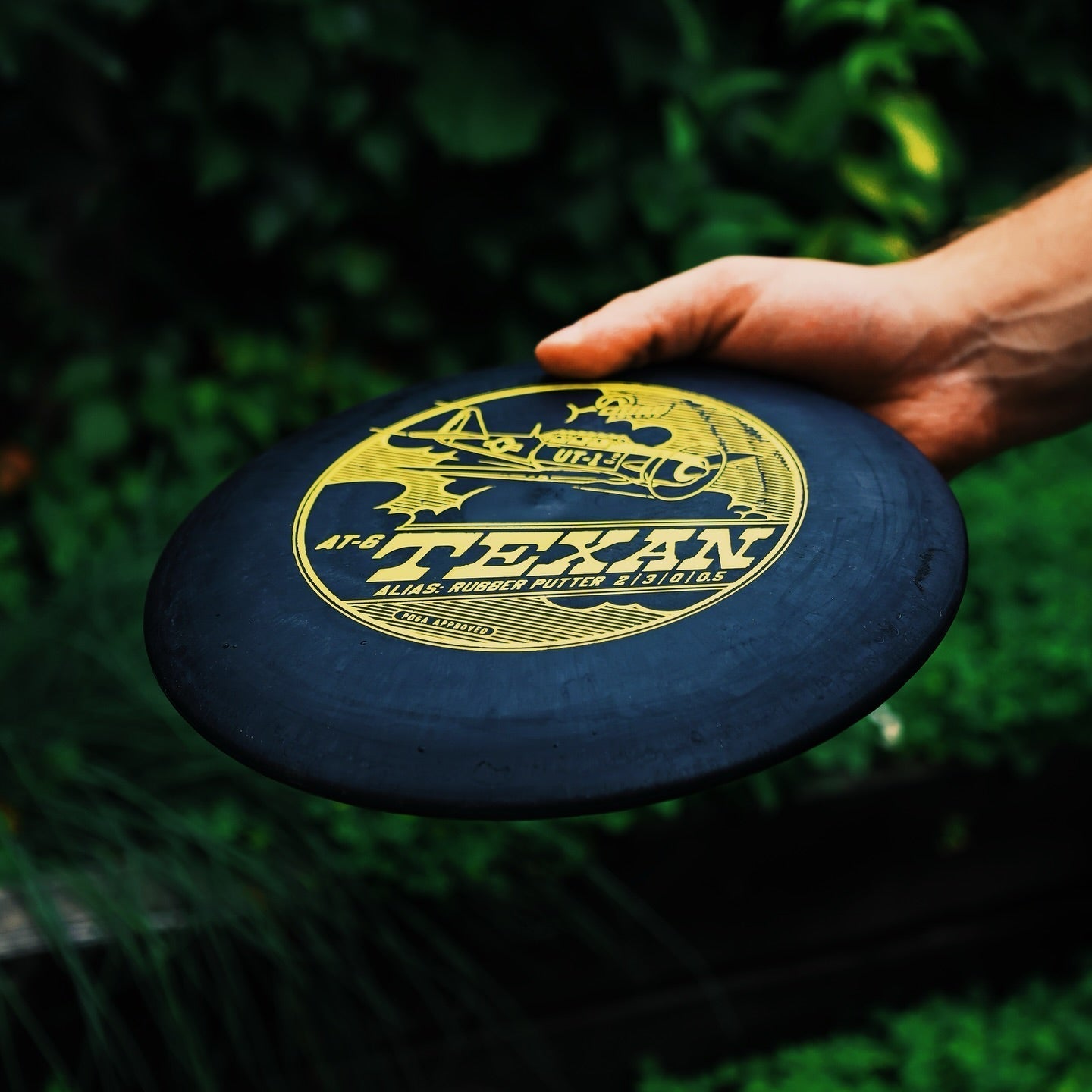 Lightning Warbird AT-6 rubber golf disc by Lightning Golf Discs, featuring a sleek design and bright colors for disc golf gameplay.