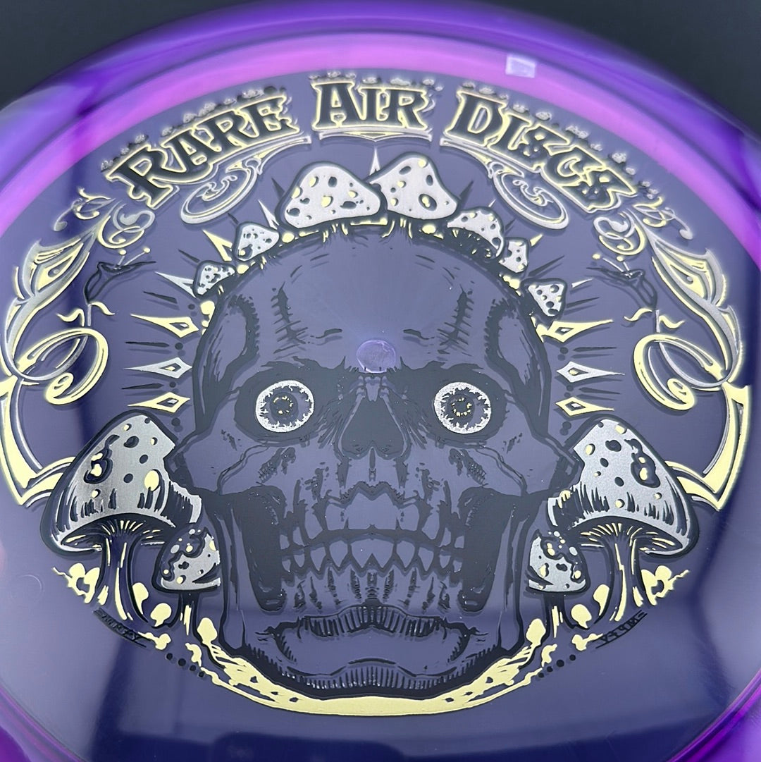 Disc golf stamp by Manny Trujillo on Rare Air Discs' Ethos Construct Crushin' Amanitas disc, featuring vibrant mushroom artwork.