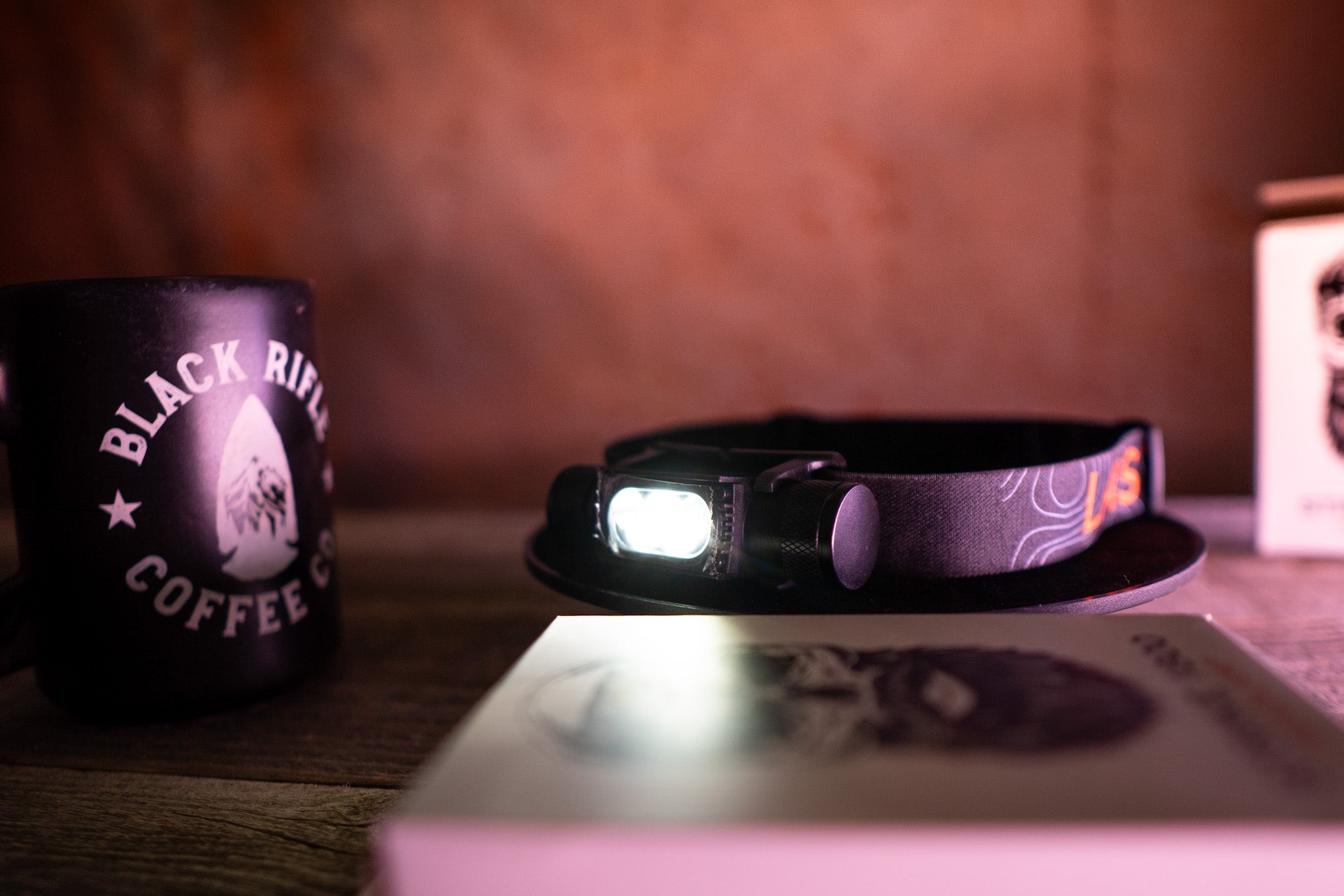 Last Light LLC Strike 1800 headlamp with adjustable strap and bright LED light for outdoor or work use.