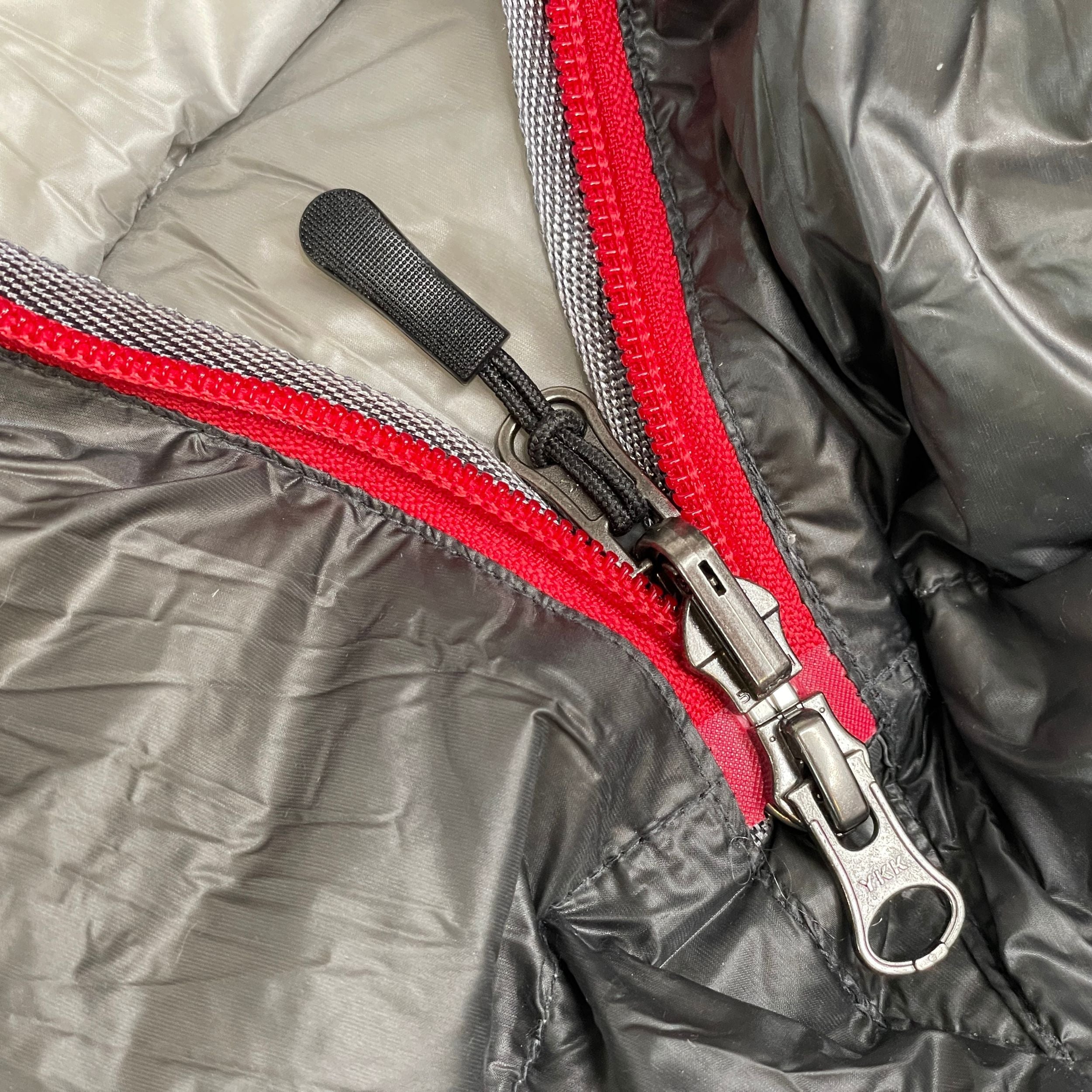Near Zero Outdoor Gear NZ 35 Mummy Sleeping Bag spread open, showing its insulated interior and compact design for outdoor camping.