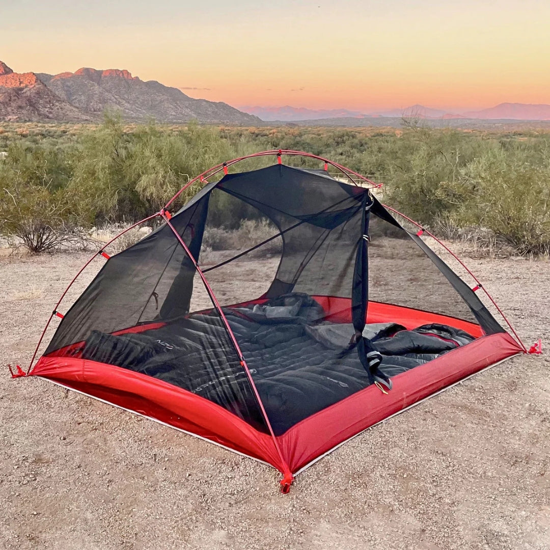 Near Zero Outdoor Gear 3P DynaLite Tent set up outdoors with open doorway and rainfly, showcasing lightweight camping tent design.