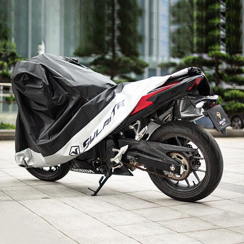 Bean's Moto Booth SULAITE™ Oxford Fabric waterproof motorcycle cover with reflective strips protecting a motorcycle from rain and UV rays.