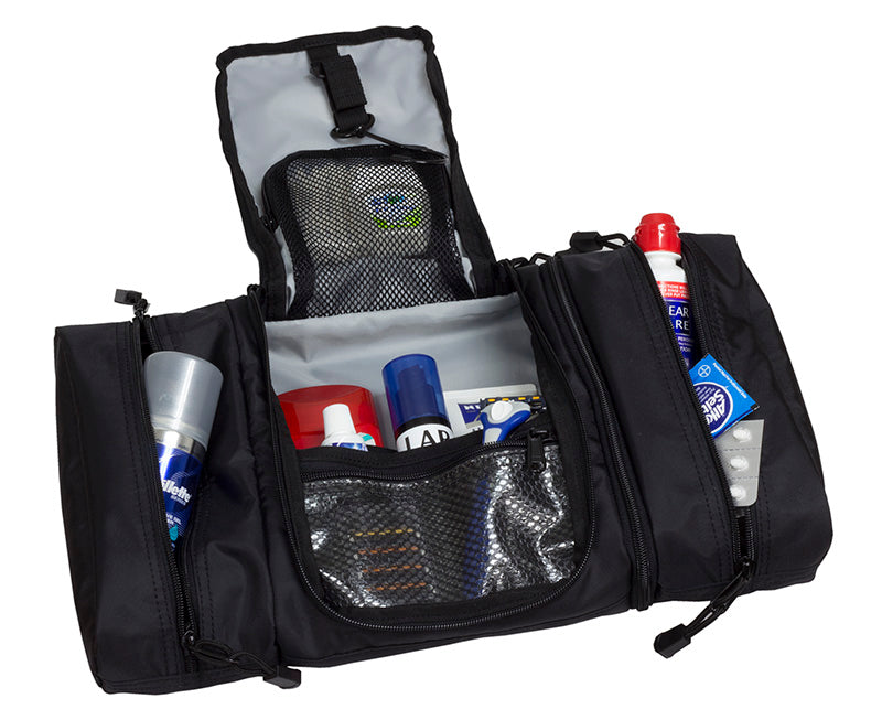 Open Elite Survival Systems Travel Prone™ toiletry kit in luggage, showing compartments and organized space for travel essentials.