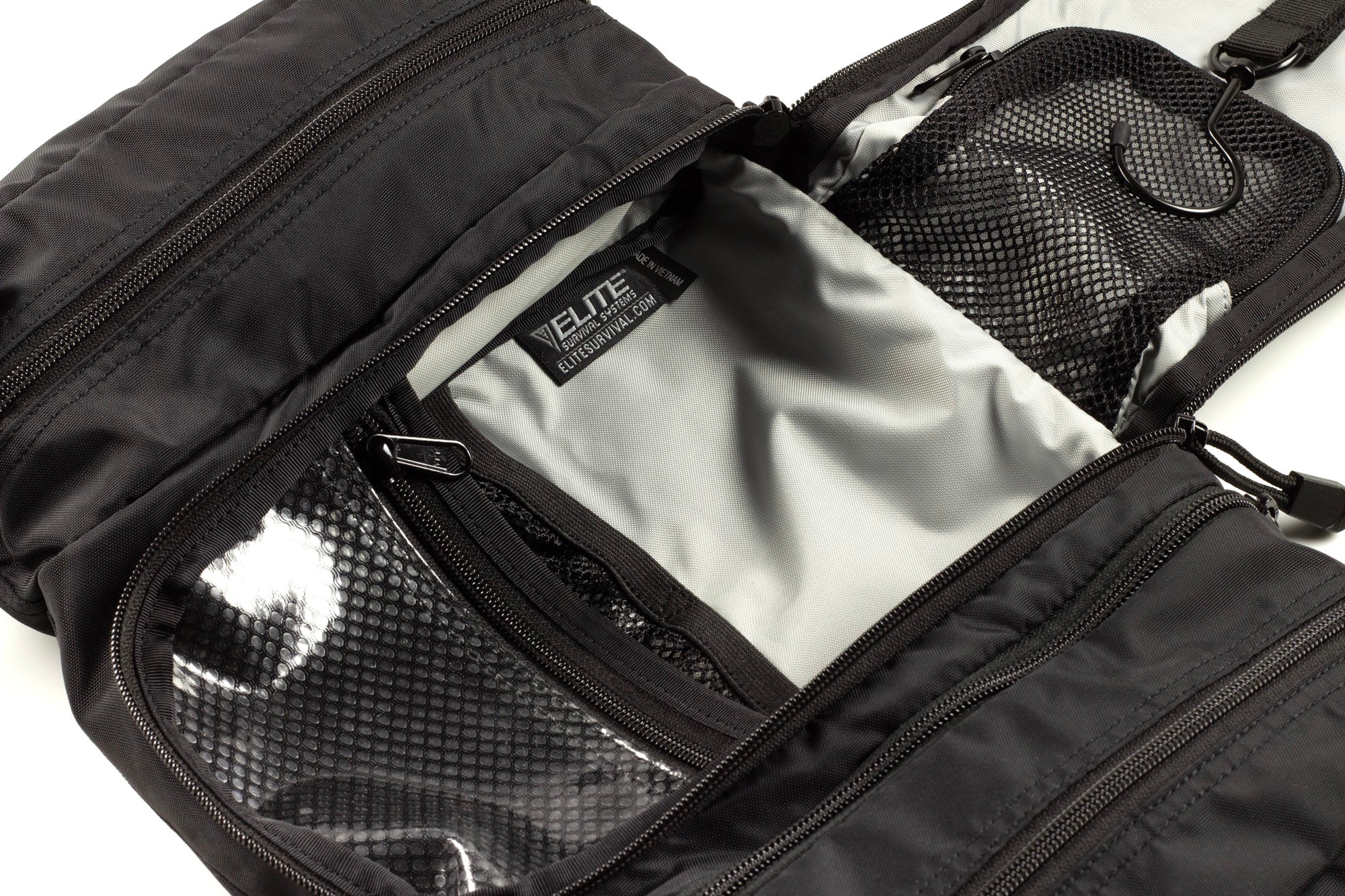 Elite Survival Systems Travel Prone™ Toiletry Kit in luggage, featuring compartments and durable material for organized travel toiletries.