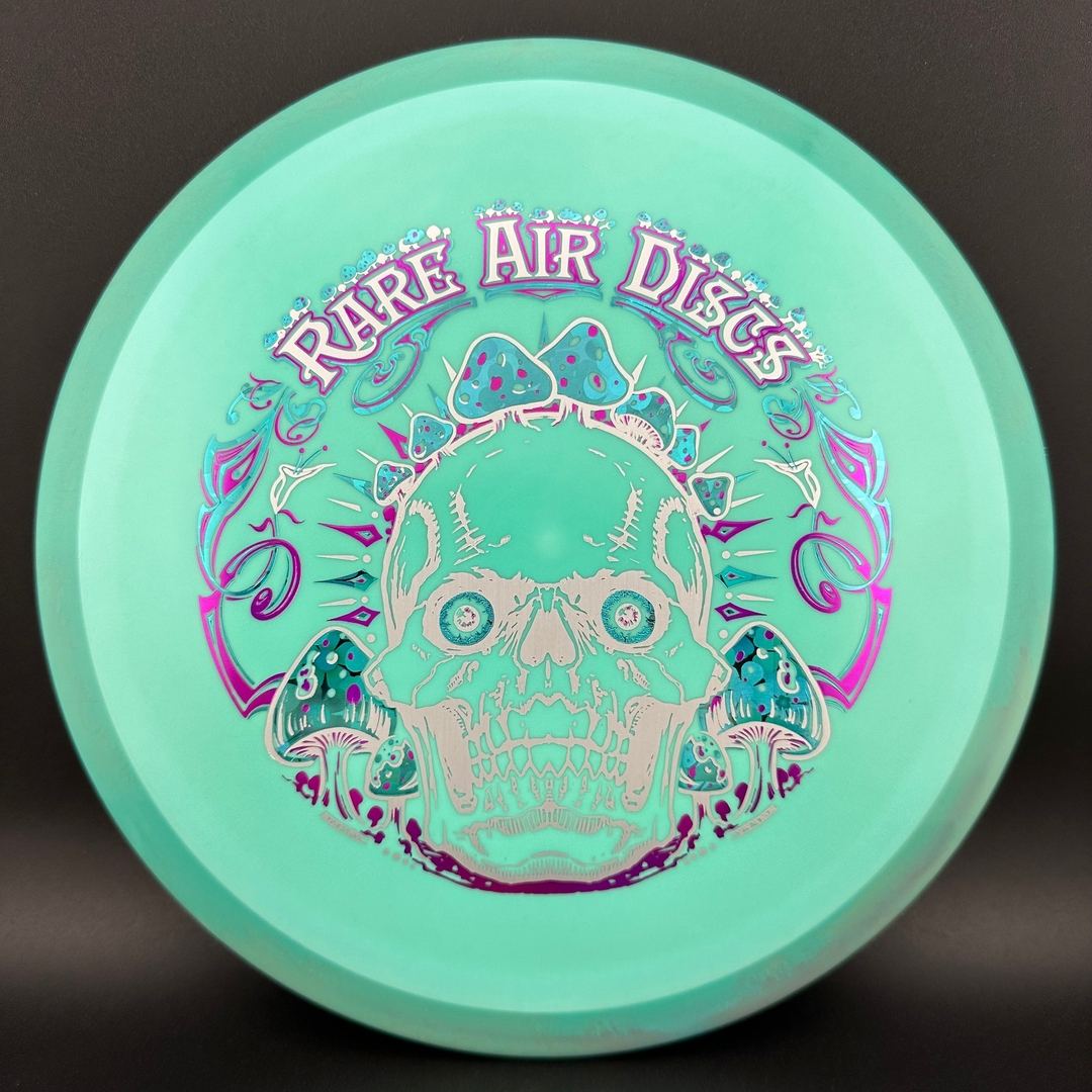 Rare Air Discs Fission Defy Crushin' Amanitas VIP 2.0 disc golf disc with colorful artwork and bold design by Manny Trujillo.