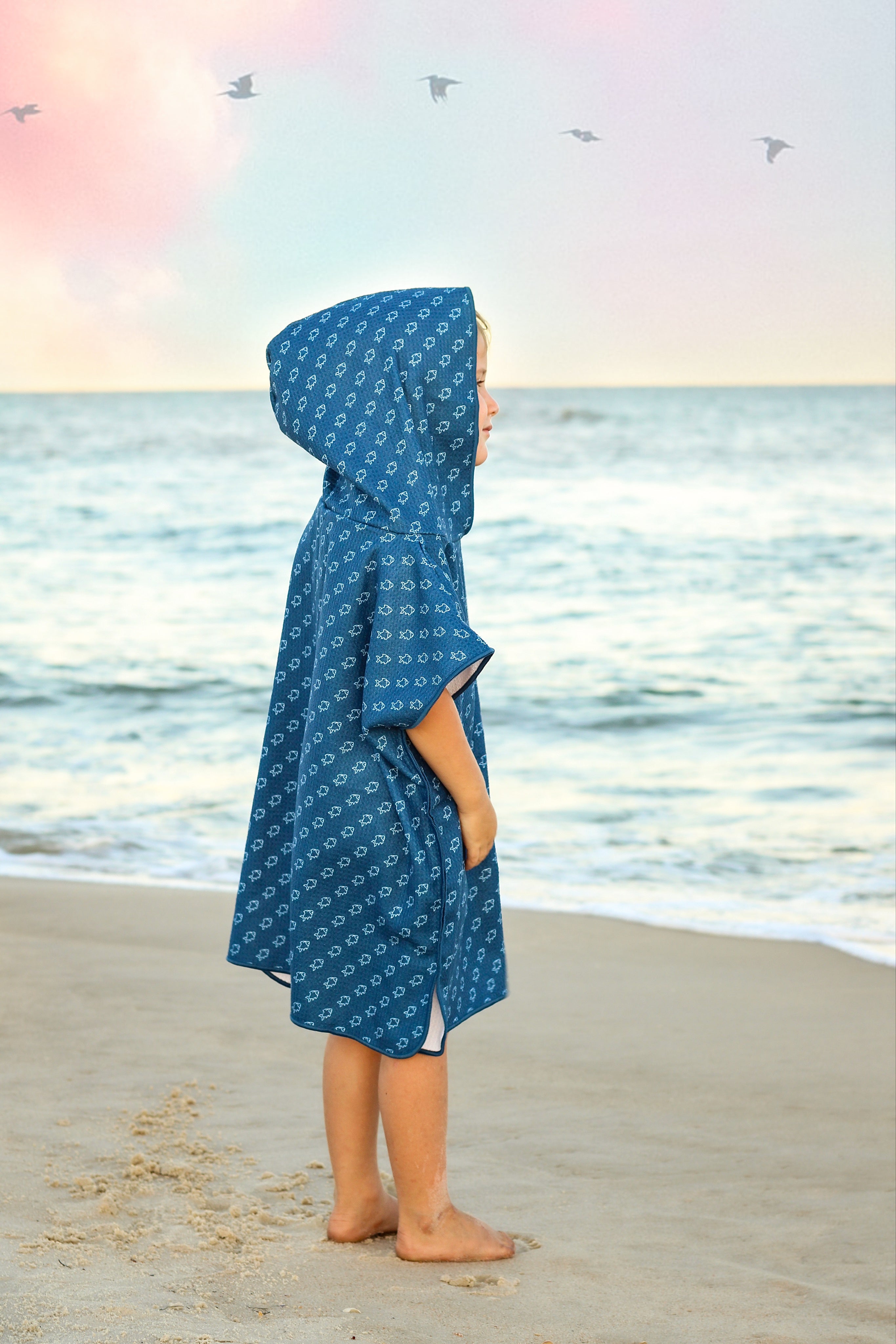 Blue microfiber fish-shaped waffle wearable towel by Keep the Littles Wild, shown draped and ready for use.