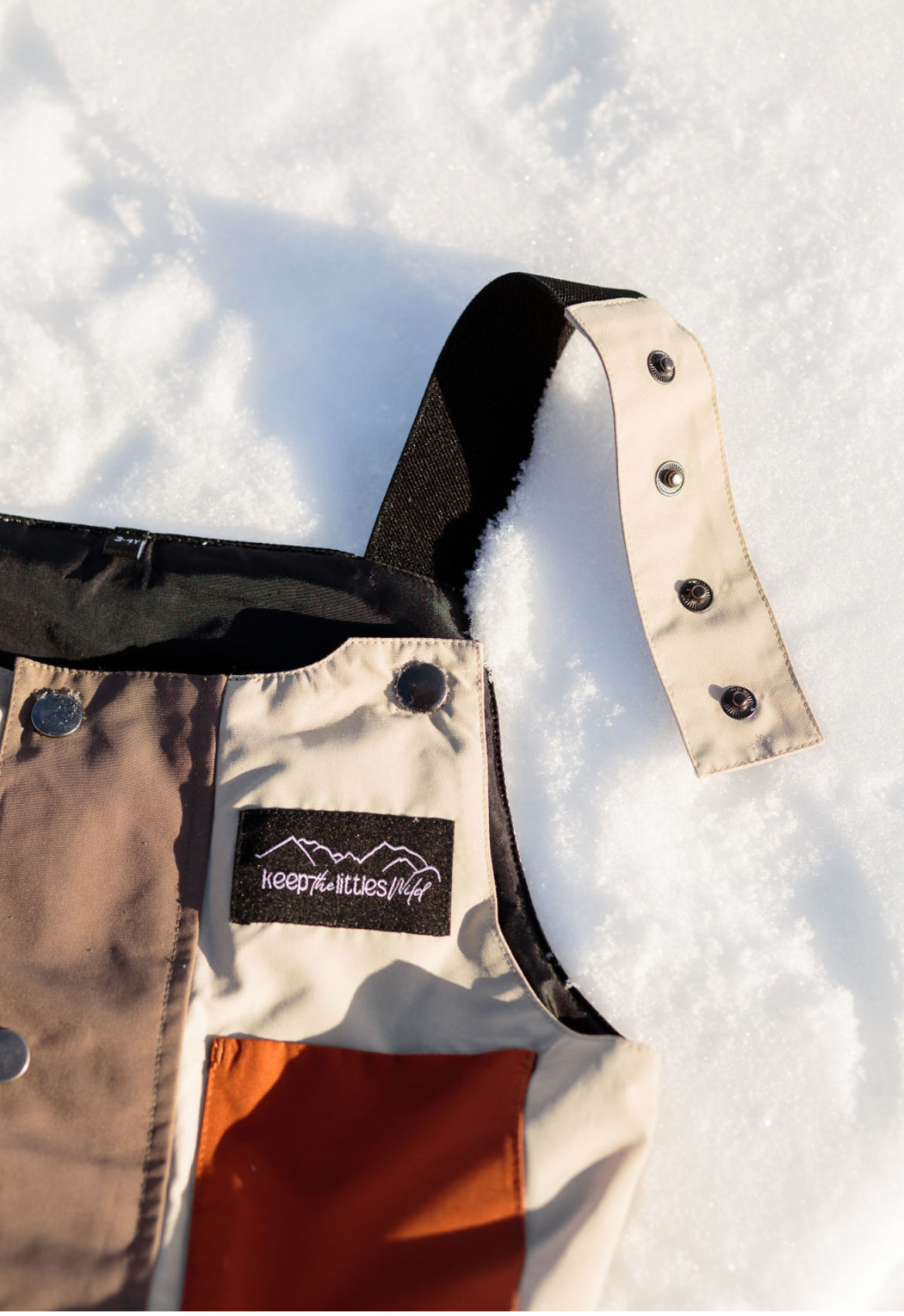 Waterproof snow bib for youth and toddlers by Keep the Littles Wild, featuring adjustable straps and insulated design for winter warmth.