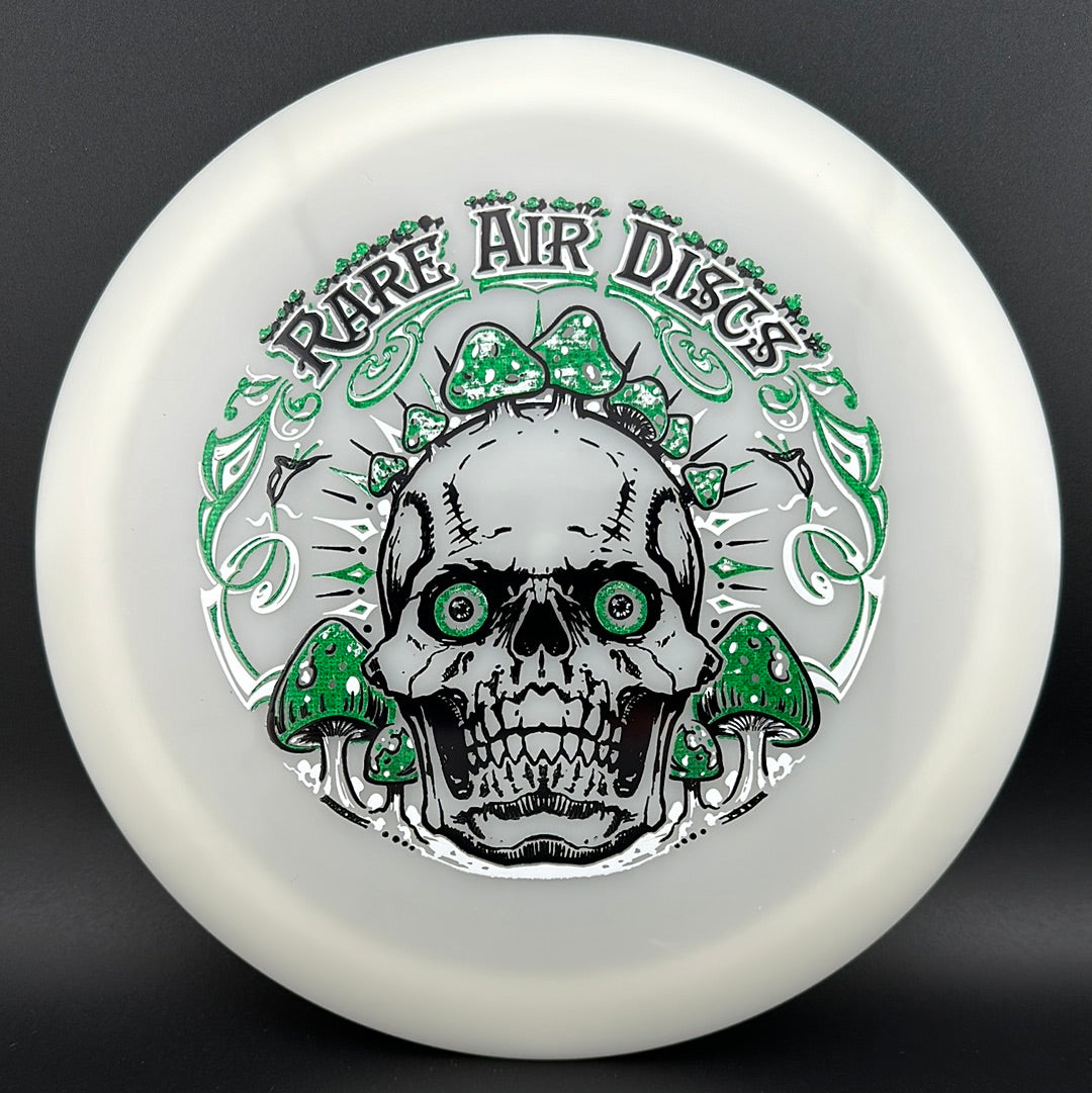 Forged Radiant Era Crushin' Amanitas disc golf stamp by Manny Trujillo on a Rare Air Discs disc, featuring vibrant artwork and detailed design.