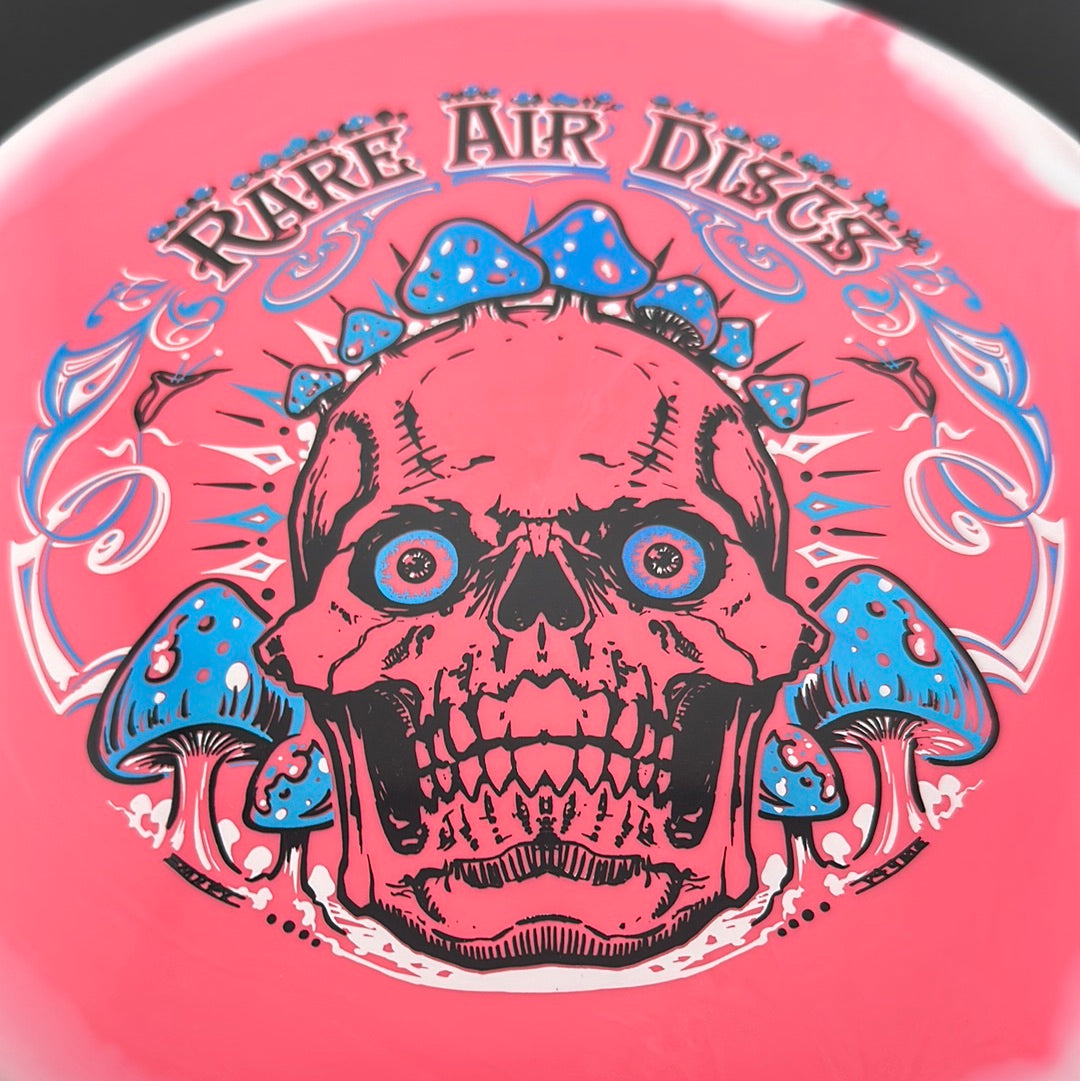 Rare Air Discs Halo S-Blend Tomb disc golf stamp by Manny Trujillo featuring Crushin' Amanitas artwork on the disc surface.