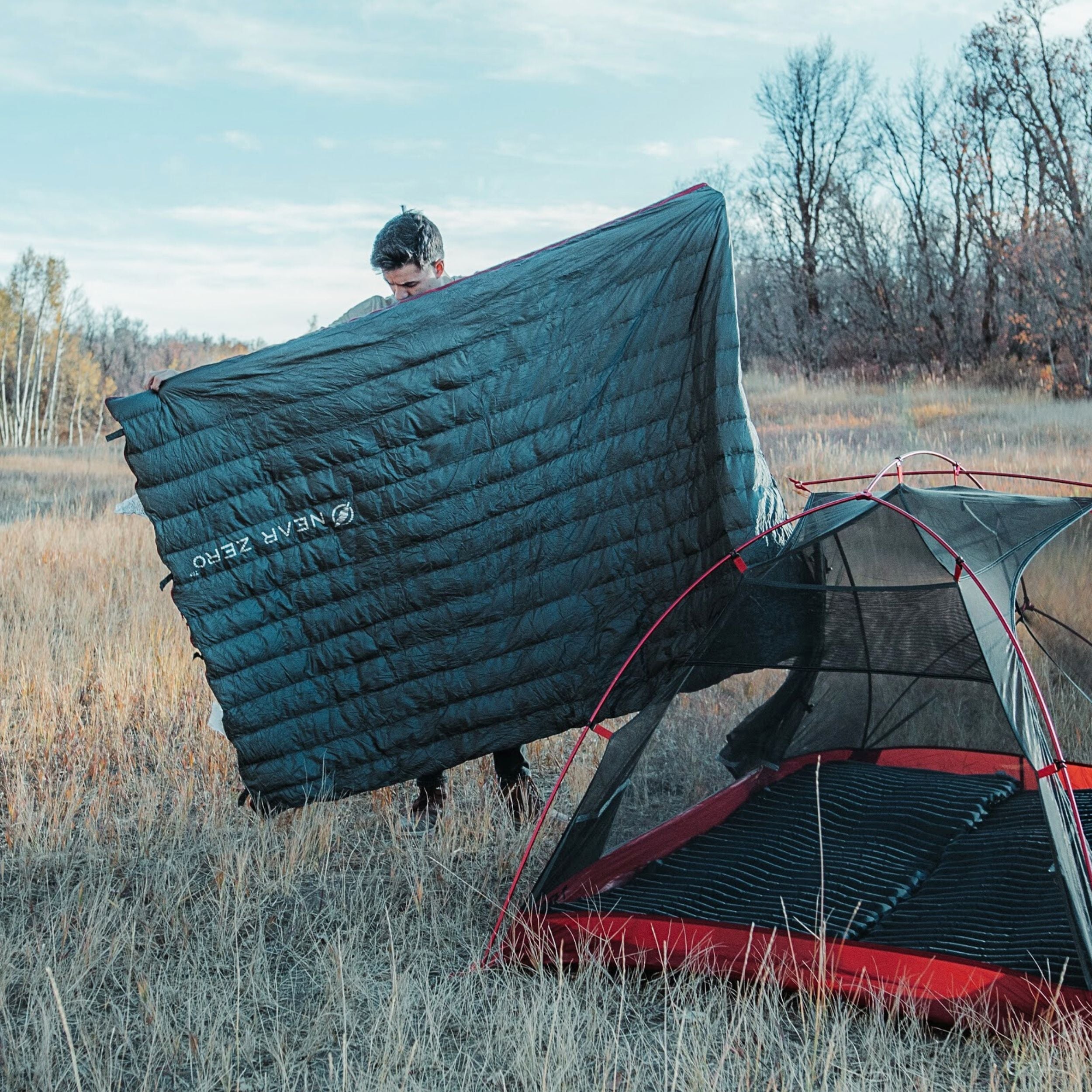 Near Zero Outdoor Gear QUILT ONE sleeping bag in a cozy, folded position showcasing its lightweight and compact design.