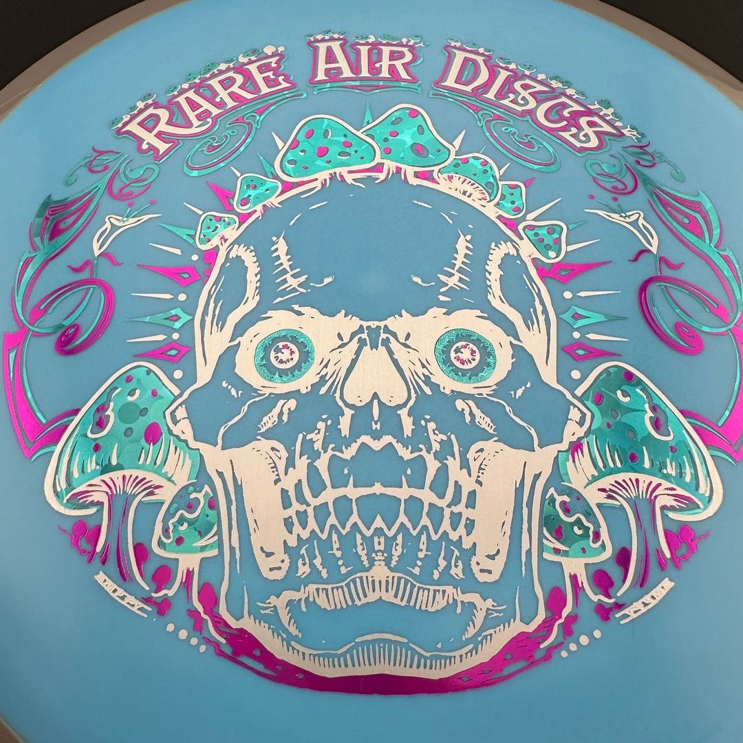 Rare Air Discs Fission Defy Crushin' Amanitas VIP 2.0 disc golf disc by Manny Trujillo, showing vibrant design and branding details.