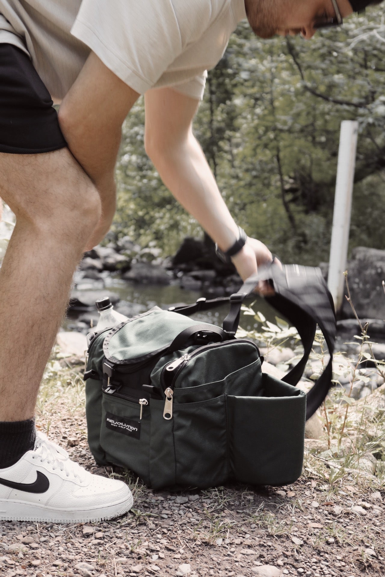 Gotta Go Gotta Throw Revolution Mini Deluxe V3 disc golf bag in Mountain Mist color with multiple compartments and adjustable straps.