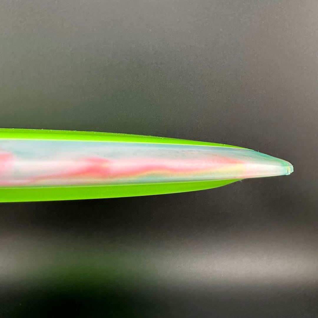 Disc golf disc Rare Air Discs Fission Defy - Crushin' Amanitas VIP 2.0 by Manny Trujillo, with vibrant design and flight markings.