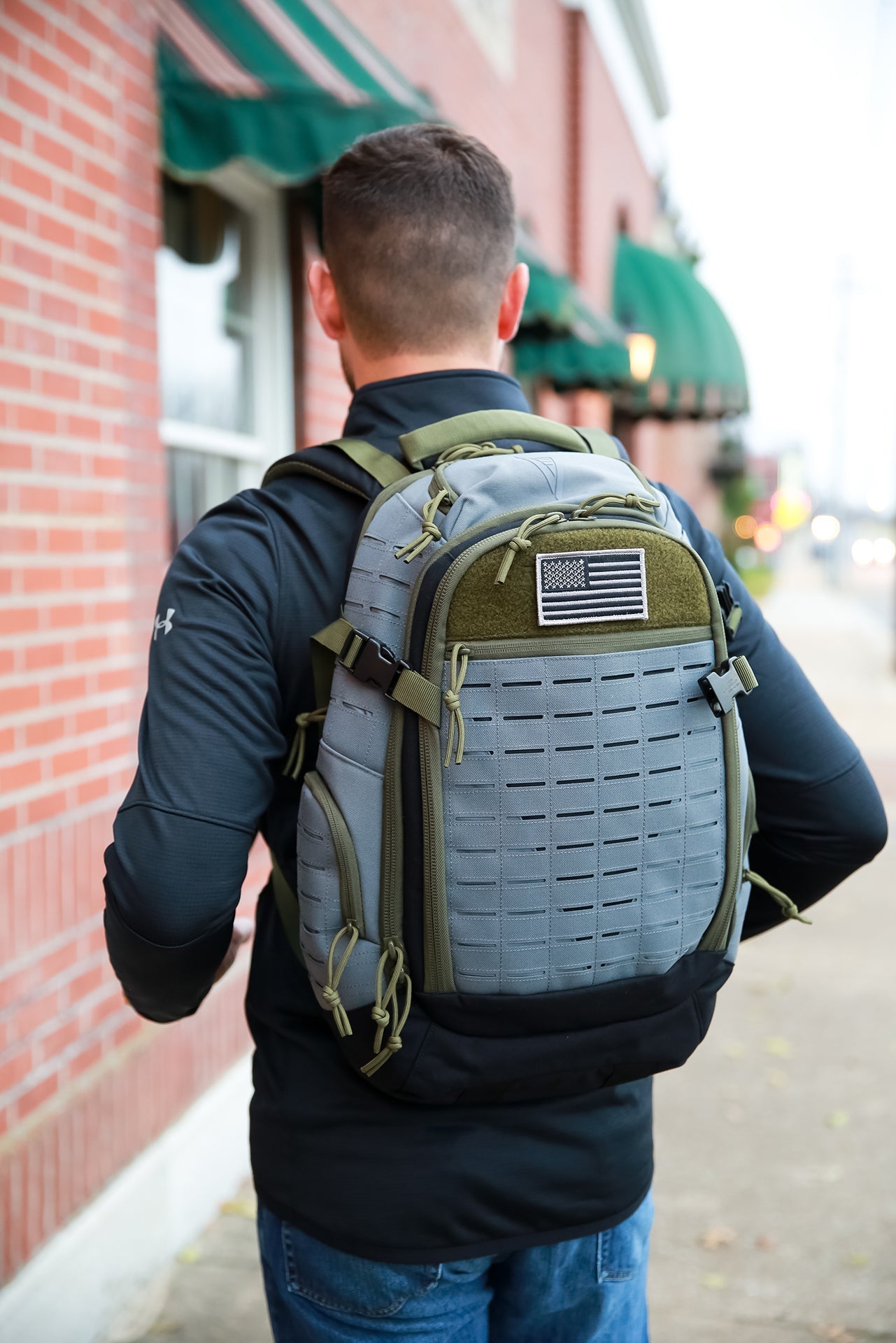 Elite Survival Systems Guardian EDC Backpack 25L in urban setting, showcasing sleek design and functional features.